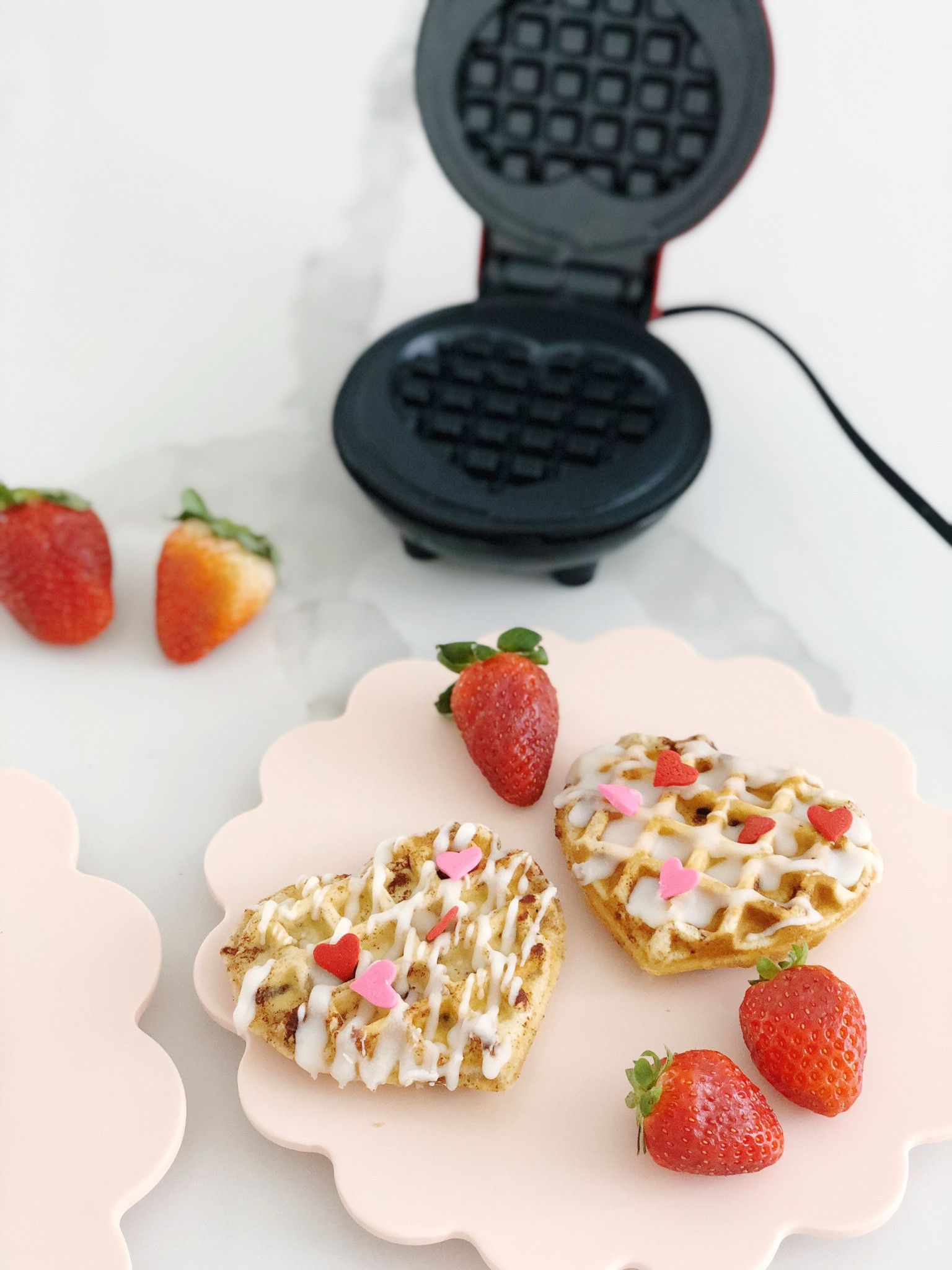 Transform hectic mornings into a delightful Valentine’s Day experience with this quick and easy breakfast idea for kids. Using a mini waffle maker and Pillsbury cinnamon rolls, you can create heart-shaped cinnamon roll waffles in minutes. Simply place a cinnamon roll in the waffle maker, cook until golden, and top with the included frosting and festive sprinkles. 

#LTKHome #LTKFamily #LTKKids
