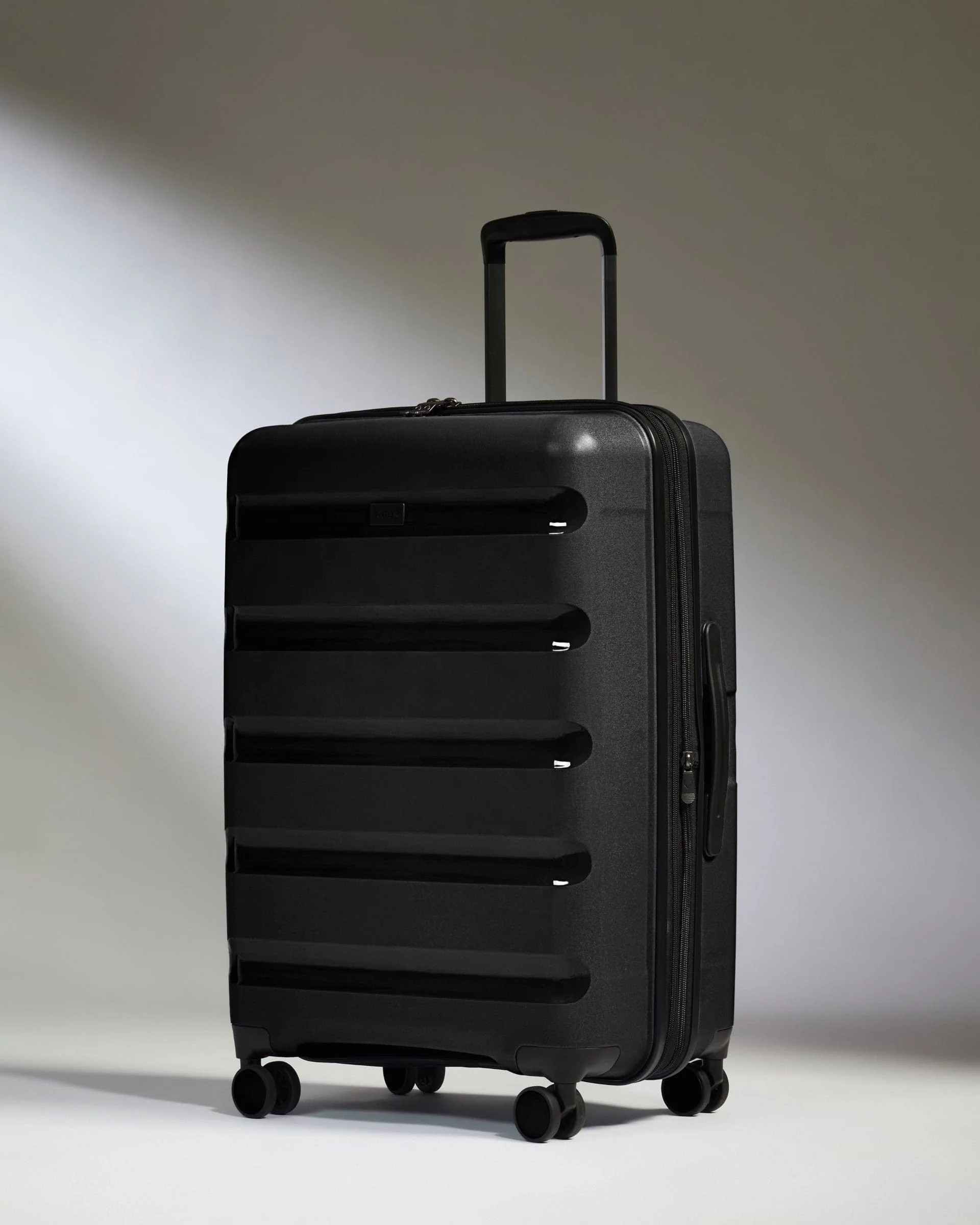 Medium Suitcase Black - Logo Stripe | Lightweight Hard Shell Luggage | Antler UK