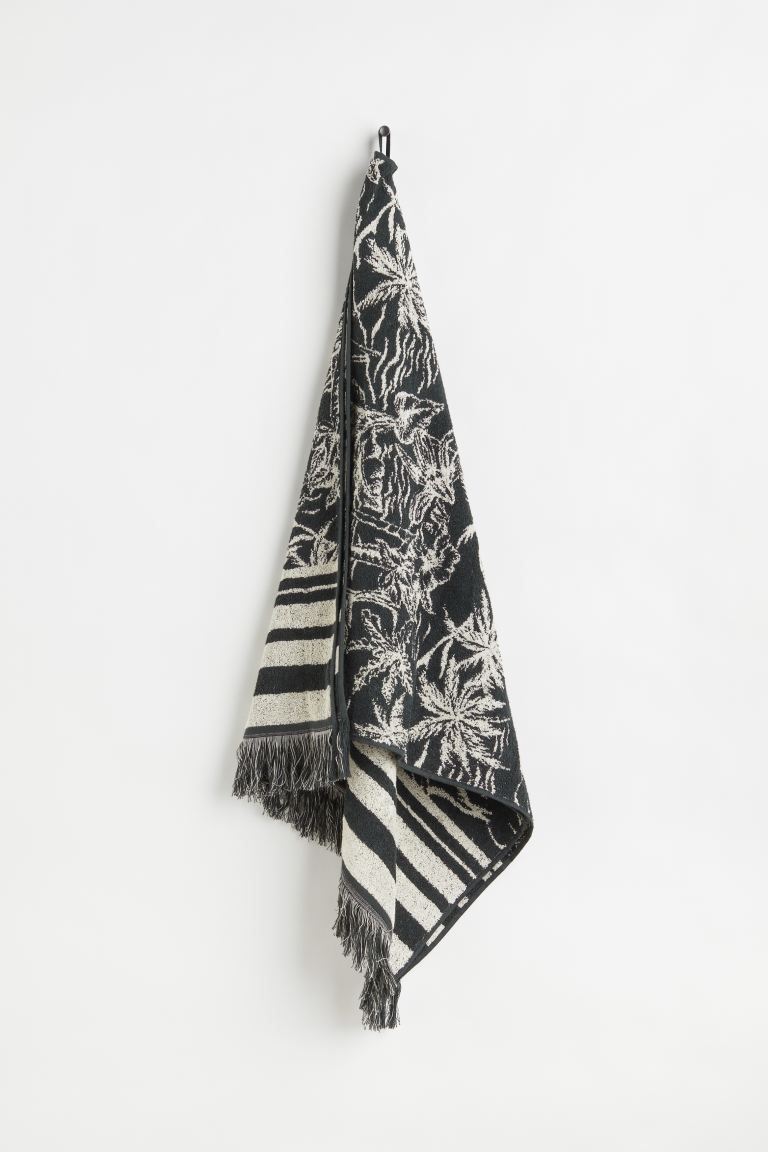 Jacquard-weave beach towel in soft cotton terry with tassels at short sides. Supplied with a prac... | H&M (US + CA)