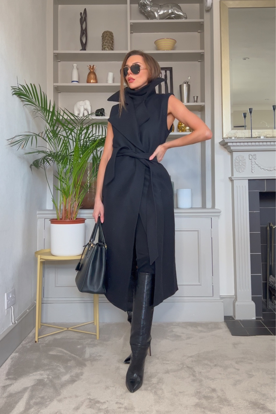 - removable sleeve black trench coat
- black knee high boots
- black aviator sunglassess