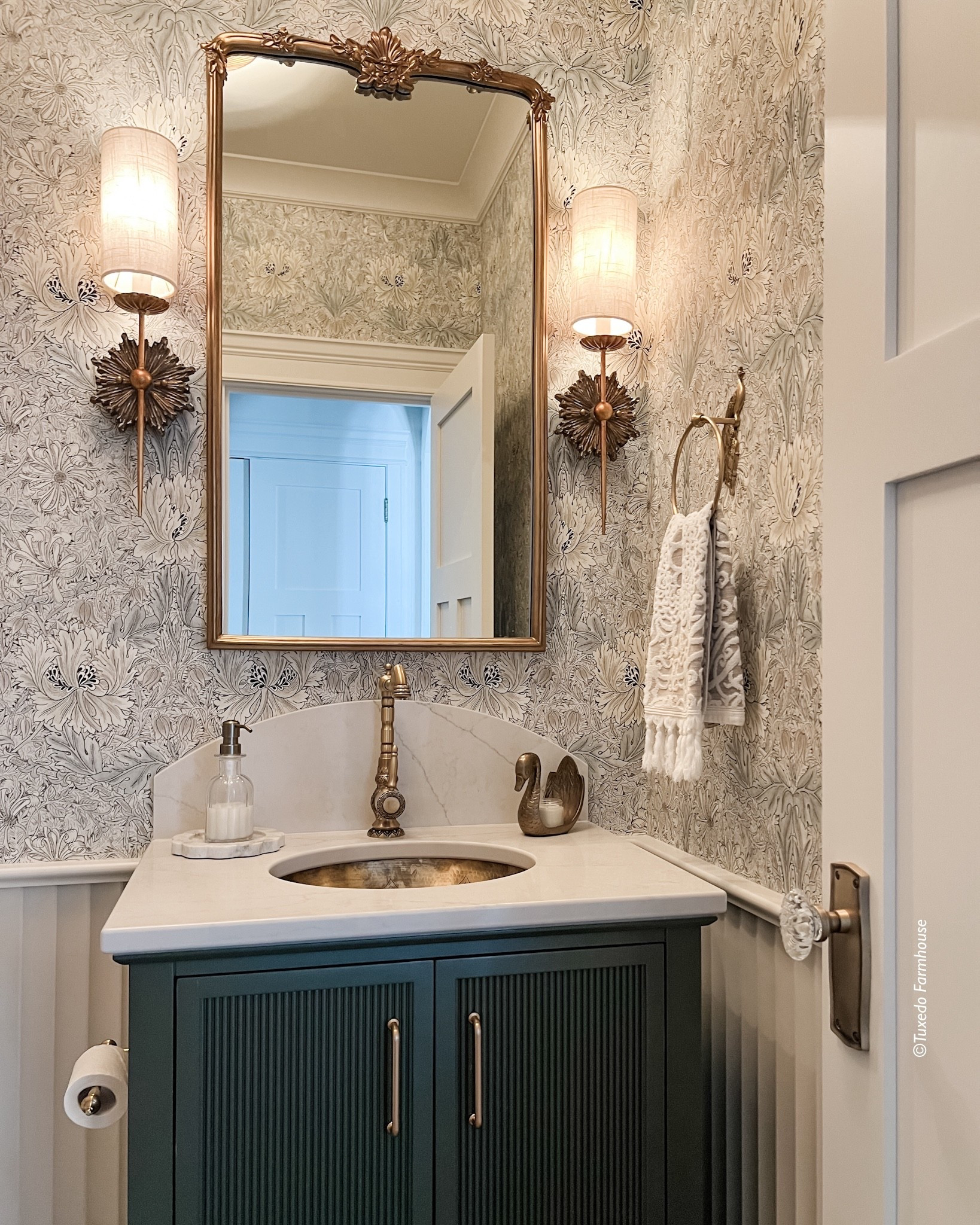 Make a lasting impression with a powder room that blends timeless elegance and thoughtful detail. Rich botanical wallpaper sets a sophisticated backdrop for warm brass finishes, while sculptural sconces cast a soft, inviting glow that enhances the room’s refined character. A beautifully framed mirror and classic marble countertop add depth and polish, perfectly paired with a statement vanity in a deep, moody hue. Finished with delicate accessories and textured linens, this space transforms everyday function into a moment of elevated style — proving that even the smallest rooms can deliver the biggest design impact. 

 

#LTKSeasonal #LTKHome #LTKSaleAlert