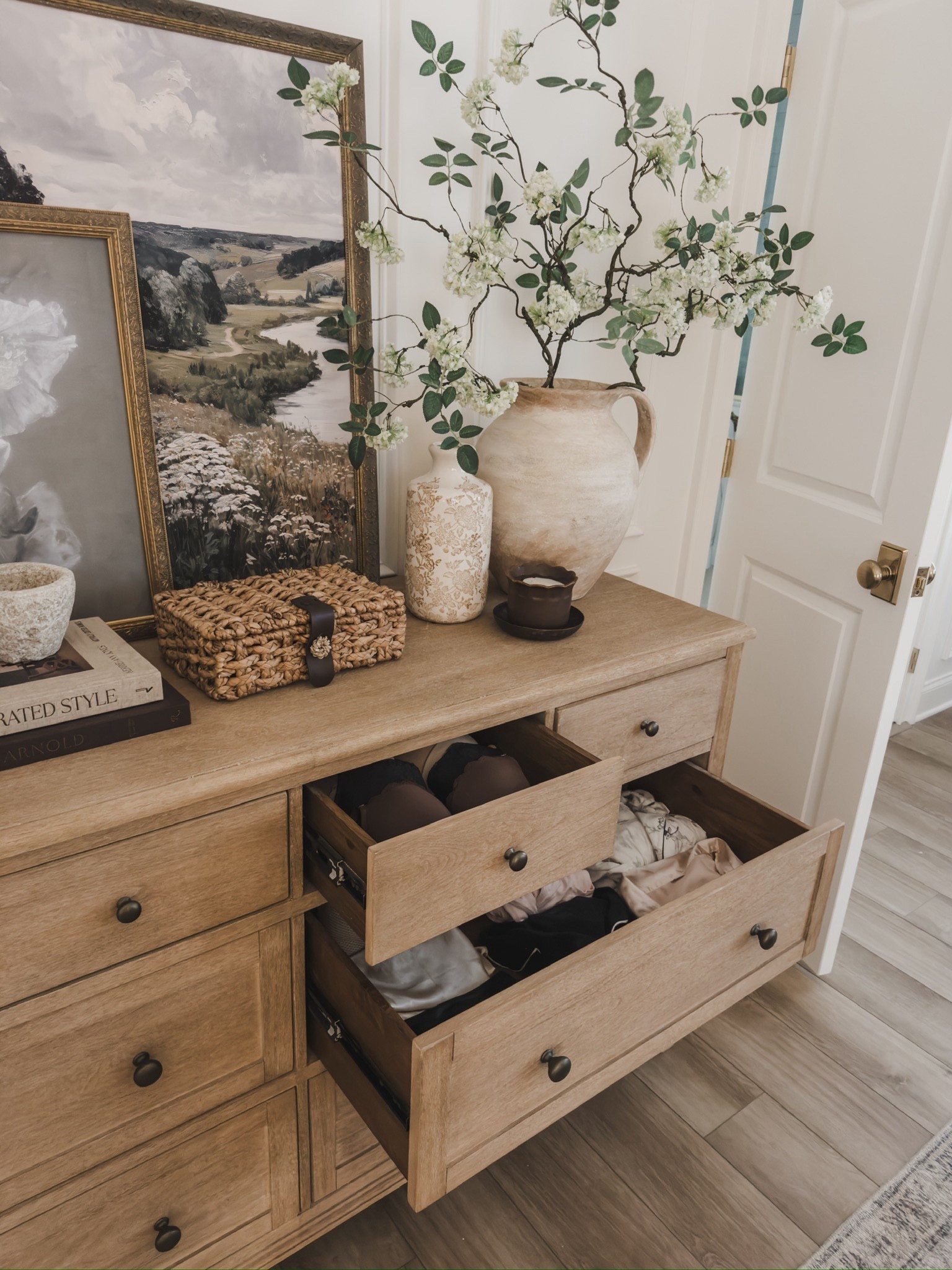 I get so many questions on my bedroom dresser! Not only is the room quality 10/10, but also functions so well. The drawers glide great and have ample room to store all the things. 

Home finds, neutral home home inspo, dresser details, furniture favorites, neutral wood tones, bedroom dresser, collected style, faux floral, digital art, vase details, woven storage box, look for less, quality over quantity, Pottery Barn style, found it on Amazon, Michael’s, Etsy, neutral decor book, vintage style frame, Emtek, wainscoting detail, shop the look!

#LTKHome #LTKSeasonal