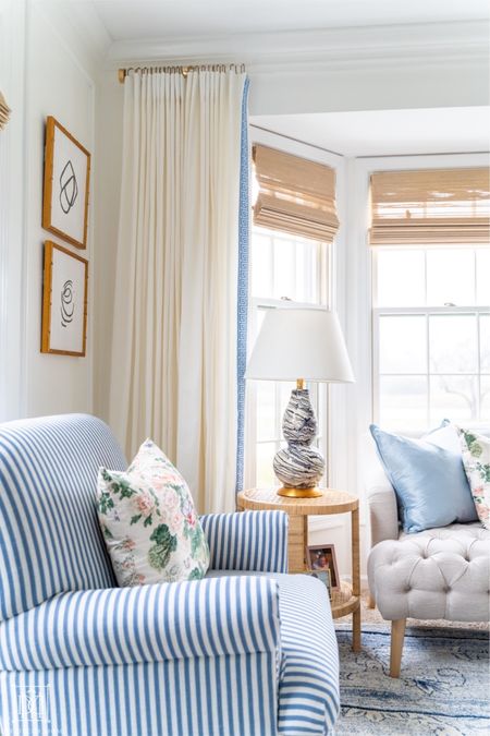 Grandmillennial blue and white living room with rattan wrapped side table and curtains with lucite curtain rod. Blue stripe side chair  

#LTKhome