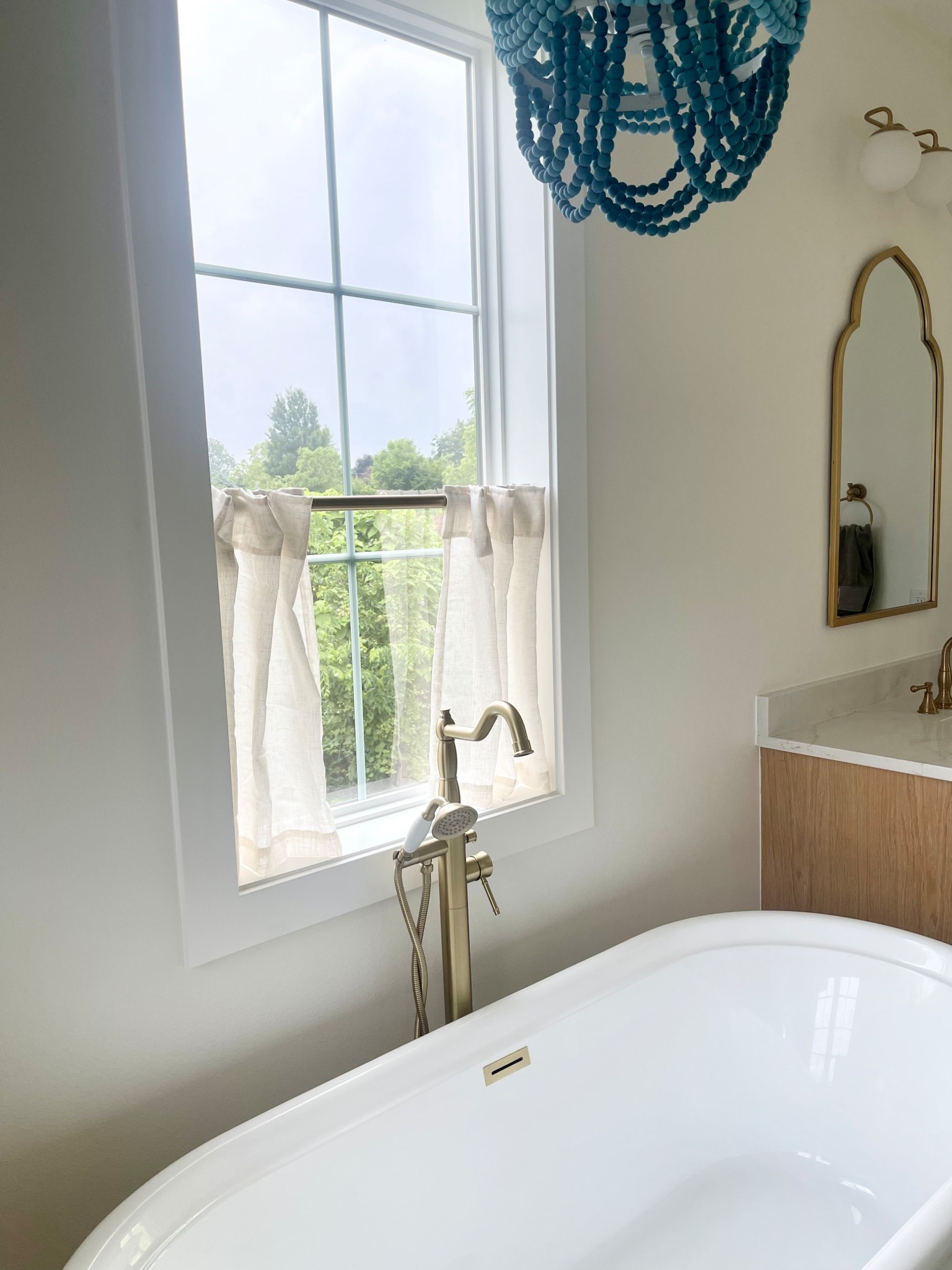 Bathtub linen cafe curtain! Gold tension rod and gold bathroom vintages! 

#LTKHome