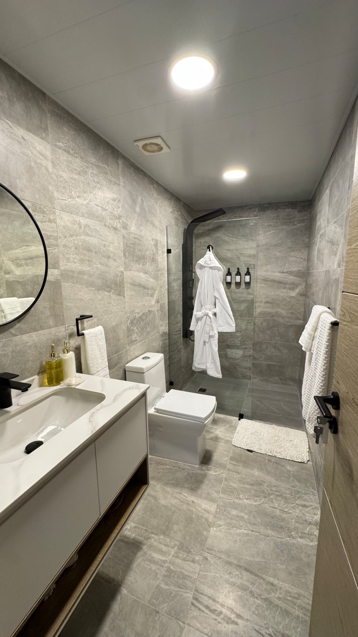 Bathroom styling | bathrobe | Shampoo, Shower Gel , conditioner wall dispenser | Hand Soap , Hand Lotion Dispenser | Towel set | Faucet | Towel holder | round mirror | 

#LTKHome