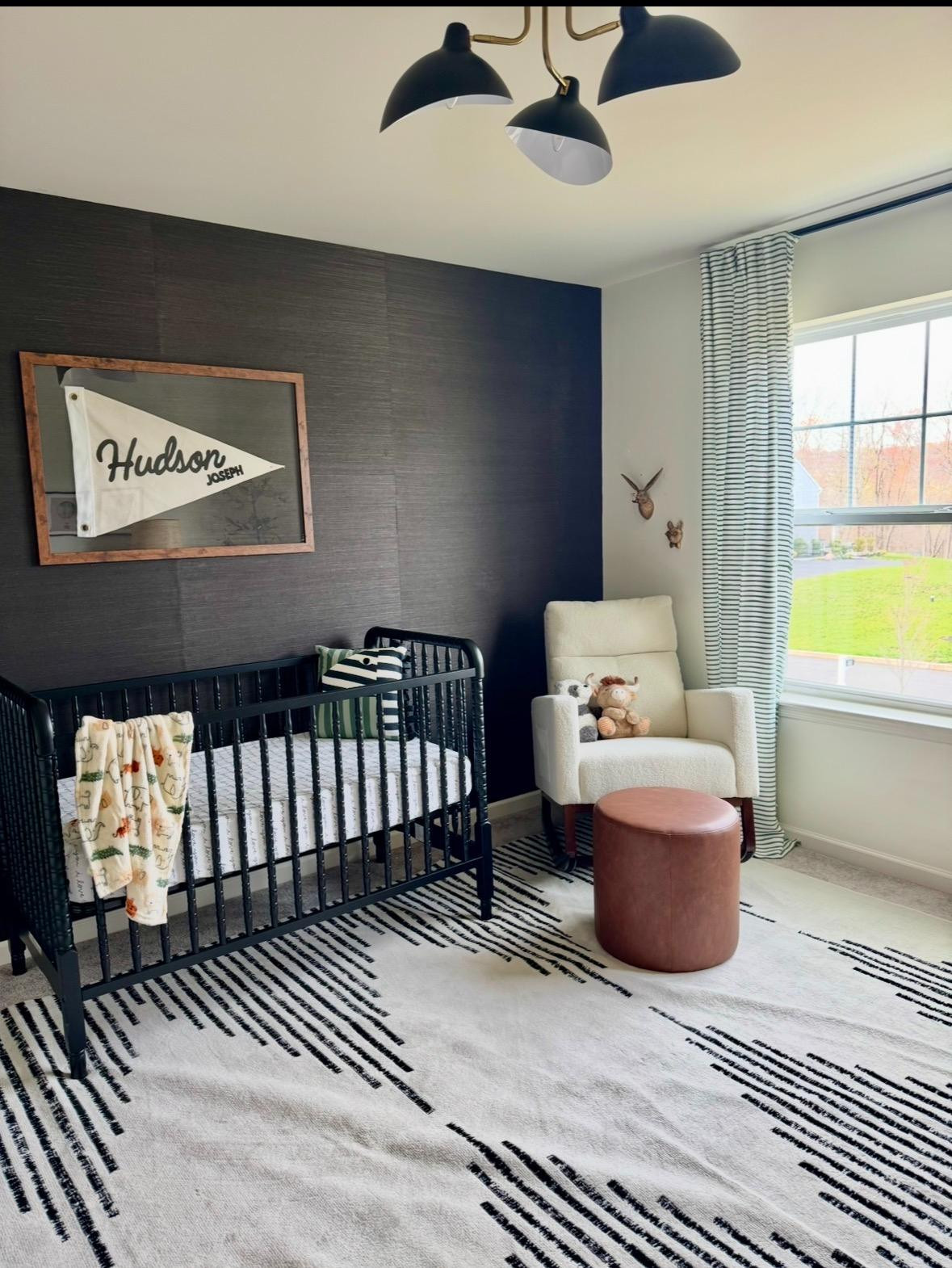 Designing a nursery that feels elevated and able to grow with your child was my top priority. I skipped anything overly themed and focused on timeless pieces with texture and contrast instead.

The black crib adds a modern edge against the moody accent wall, while the mid century modern lighting keeps the space feeling classic and architectural. I layered in warm wood tones with the ribbed dresser (that doubles as a changing station!) and balanced it with a cozy cream glider that will transition beautifully into a reading nook someday.

The striped curtains and graphic rug add just enough pattern without overwhelming the room — and they’ll still feel right at home in a toddler or big kid space. This is one of those rooms where every piece works now and later, which makes it such a smart investment.

If you love kids room ideas that feel polished, cozy, and not overly “baby,” these are the pieces I used to create that grow-with-him look. 

 #LTKHome #LTKBaby #LTKKids