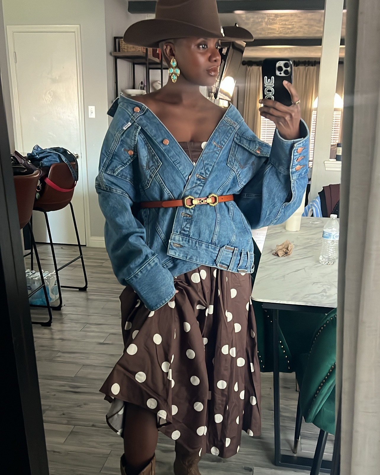 Western outfit for rodeo or festival season! Polka dot dress, oversized trucker jacket, brown cowgirl hat, brown western boots, vintage gold earrings. 

#LTKFestival #LTKSpringSale