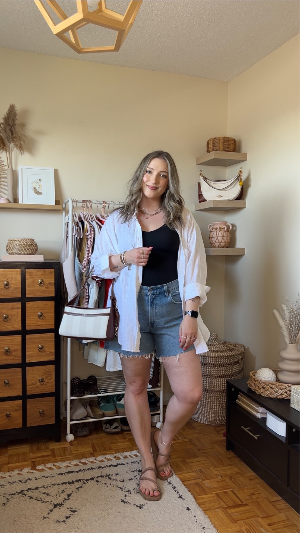 Go to summer outfit formula! Wearing M in the black tank (has a built in bra!) and L in the white button up shirt. Sized up to 32 in the denim shorts for a comfy fit. Crocs sandals are super comfortable, I’m a 9.5-10 and wear a 10. Canadian crocs link under “similar products”. Bag is Lambert

#LTKmidsize #LTKstyletip #LTKsummer