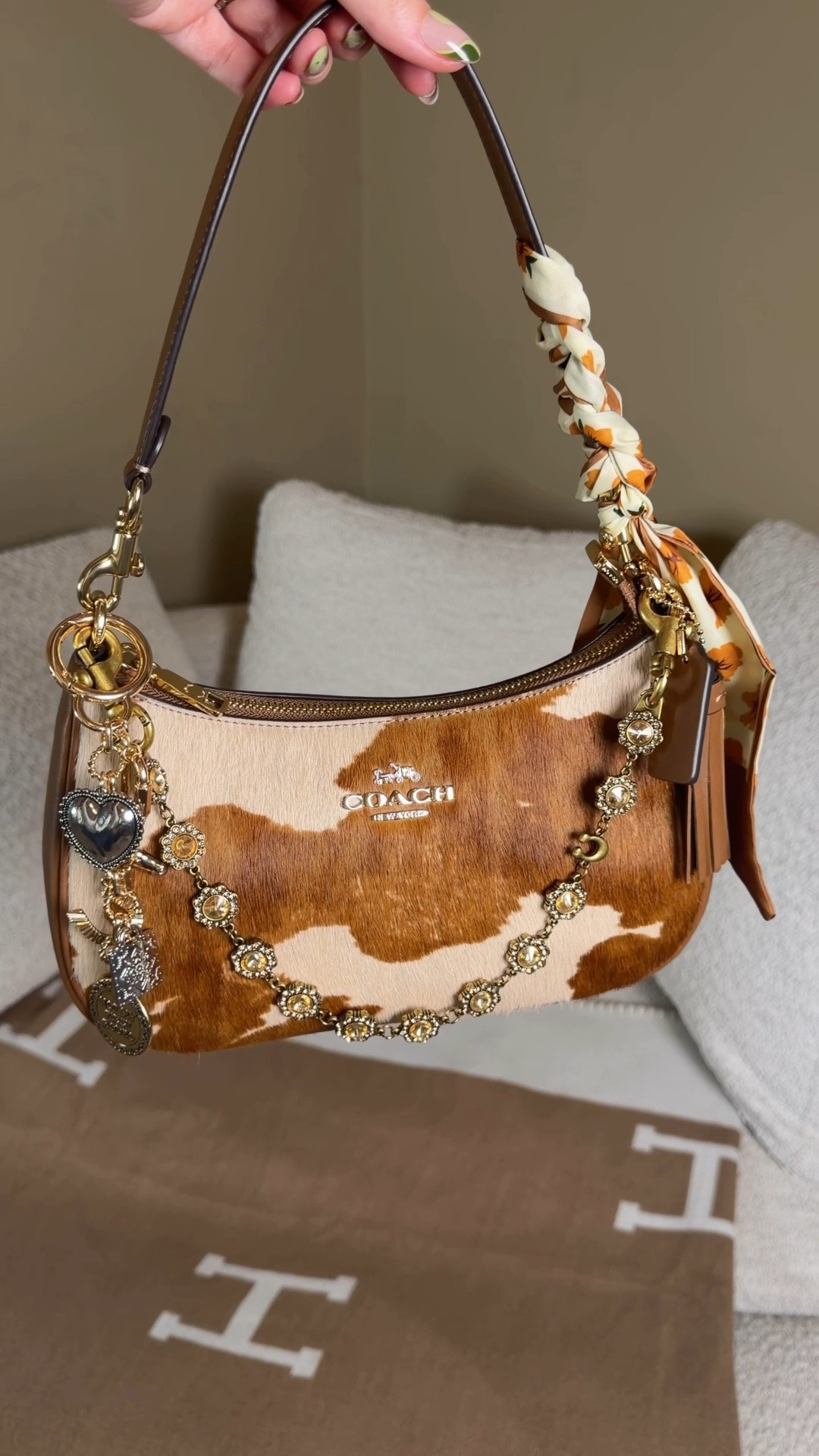Styling and packing the new Coach outlet cowhide Teri 🤠

I’m heading to a rodeo this weekend and taking my new Coach Teri in cow print so let’s pack for the rodeo (also makes the perfect finishing look for country concert outfits)!

Mini hydroflask 
Longchamp wallet
Youth to the people youth screen spf
Touchland hand mist
Light up compact mirror 
Mackenzie Childs mini hair brush
French hair pin
Bag chain
Not my first rodeo western bag charm from target
Twilly from Amazon

#LTKootd #LTKdayinmylife #LTKgrwm