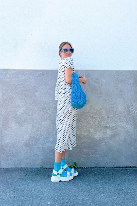 Summer Set. Fashion Blogger Girl by Style Blog Heartfelt Hunt. Girl with blond hair wearing a polka dot summer set, blue oversized sunglasses, blue flower hair clip, blue statement bag, blue socks and chunky sandals. #summerset #polkadots #chunkysandals #colorfuloutfit #colorfulstyle #colorfulfashion #colorfullooks #fashionfun #cutesummeroutfit #summerfashion2023 #summerlookbook #fitcheck #dailylooks #dailylookbook #contentcreator #microinfluencer #discoverunder20k