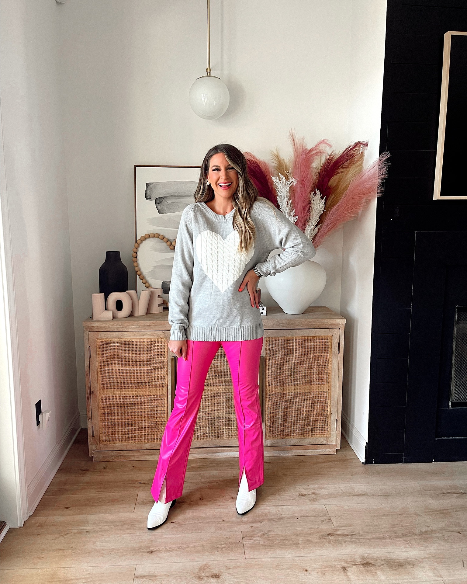 In a medium knit heart sweater, medium leather flare split hem pants & boots for Valentine’s Day from Amazon - all fits TTS.

#LTKunder50 #LTKstyletip #LTKSeasonal