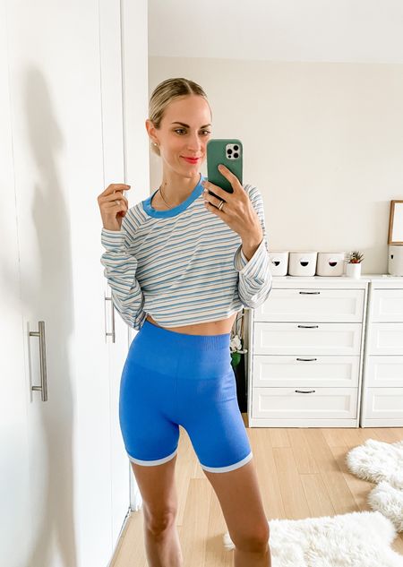 Loving this blue color!!! Top is so soft and biker shorts are 🤌🏼 Everything fits TTS and striped pants top is meant to be boxy. Shop Thursday March 9th for the exclusive sale! 

#LTKunder50 #LTKSale #LTKfit