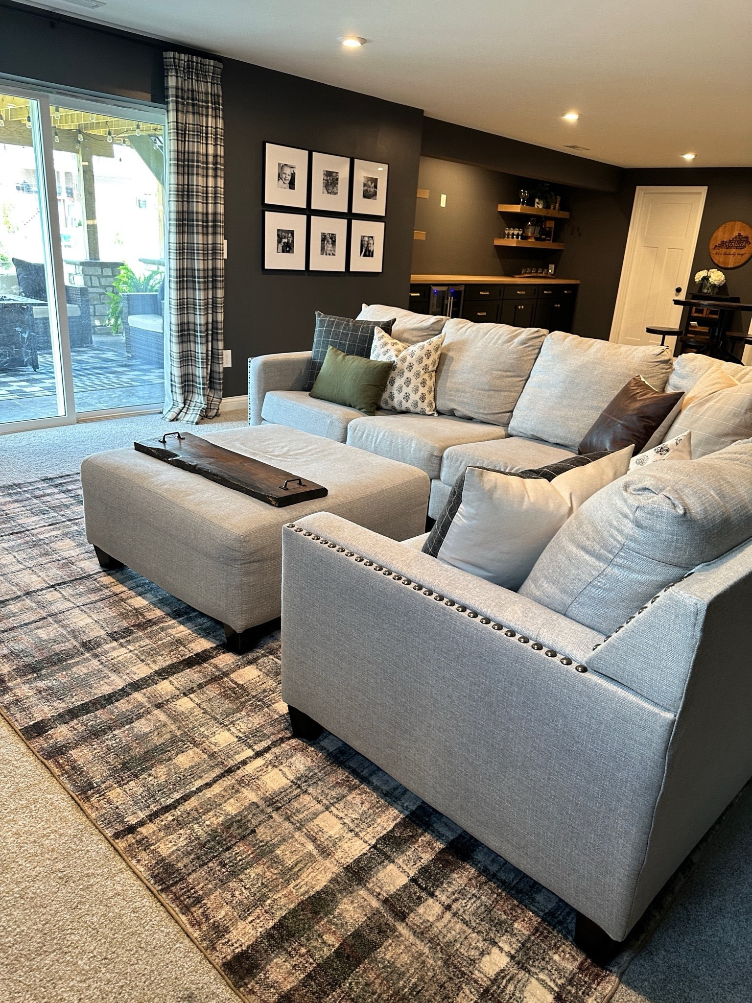 Moody design, Loloi rug, pinch pleat curtains, sectional couch, basement design, open shelving 

#LTKHome