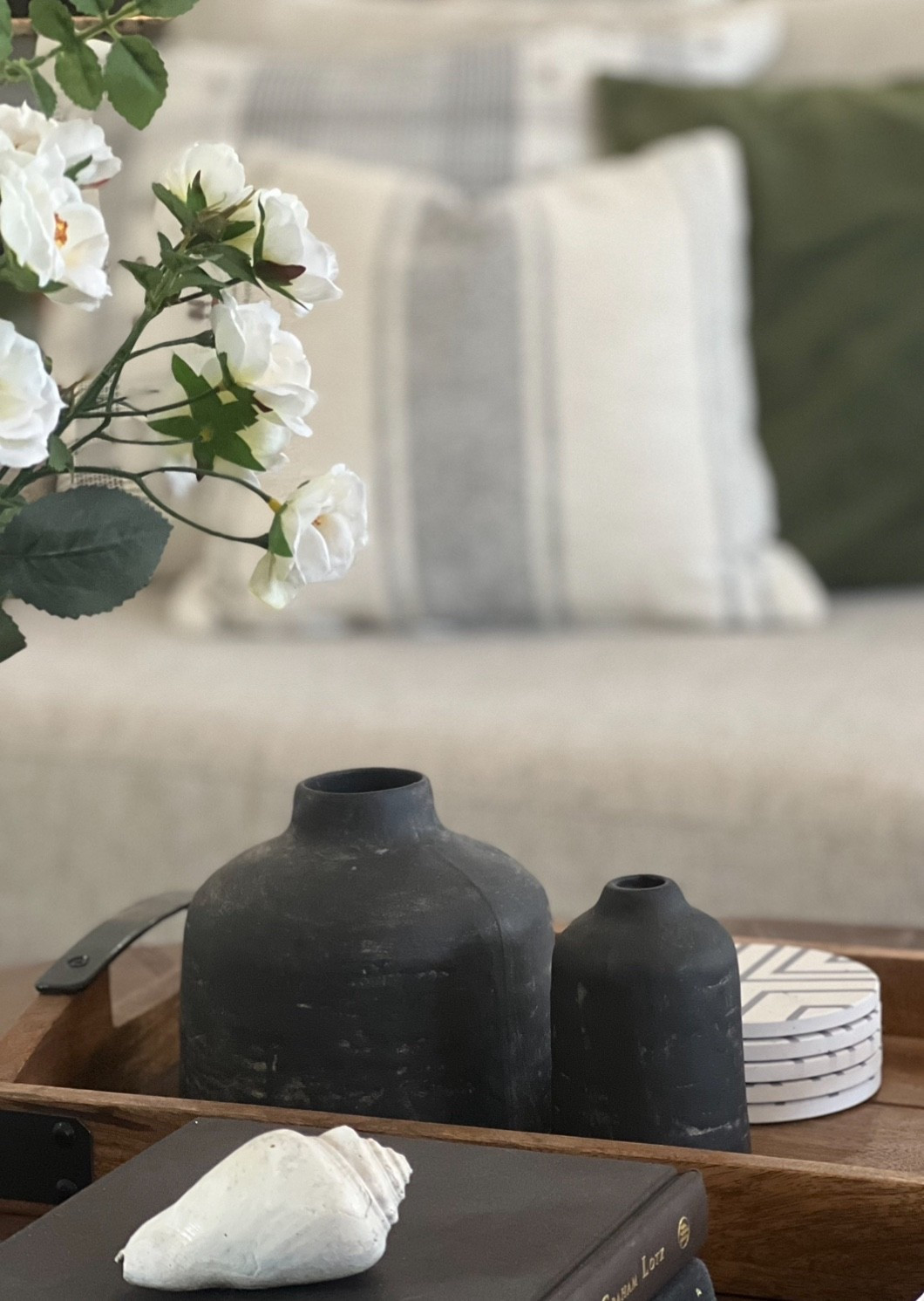 This little Hearth and Hand vase has been with me for years and I still reach for it. Linking similar black ceramic vases, a wood tray, and faux spring stems  to get the same layered feel.

#LTKHome