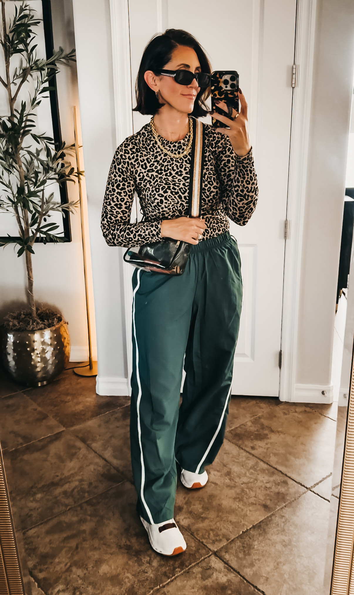 Sporty meets leopard and I’m here for it 🐆 These green track pants with the side stripe are the perfect way to dress down a leopard top without losing any of the fun — comfy, elevated, and easy to throw on and go. 

• ribbed knit leopard tee - size, small • track pants - size small ￼

• Added a gold chain and my go-to crossbody to keep it from feeling too “athleisure.”

This combo is giving off-duty but still put together — exactly the vibe I’m chasing lately!! 

Walmart, Walmart, fashion, sports Mom outfit, fall outfit idea, Mom uniform, sideline style, what to wear to a game ￼

#LTKootd #LTKOver40 #LTKActive