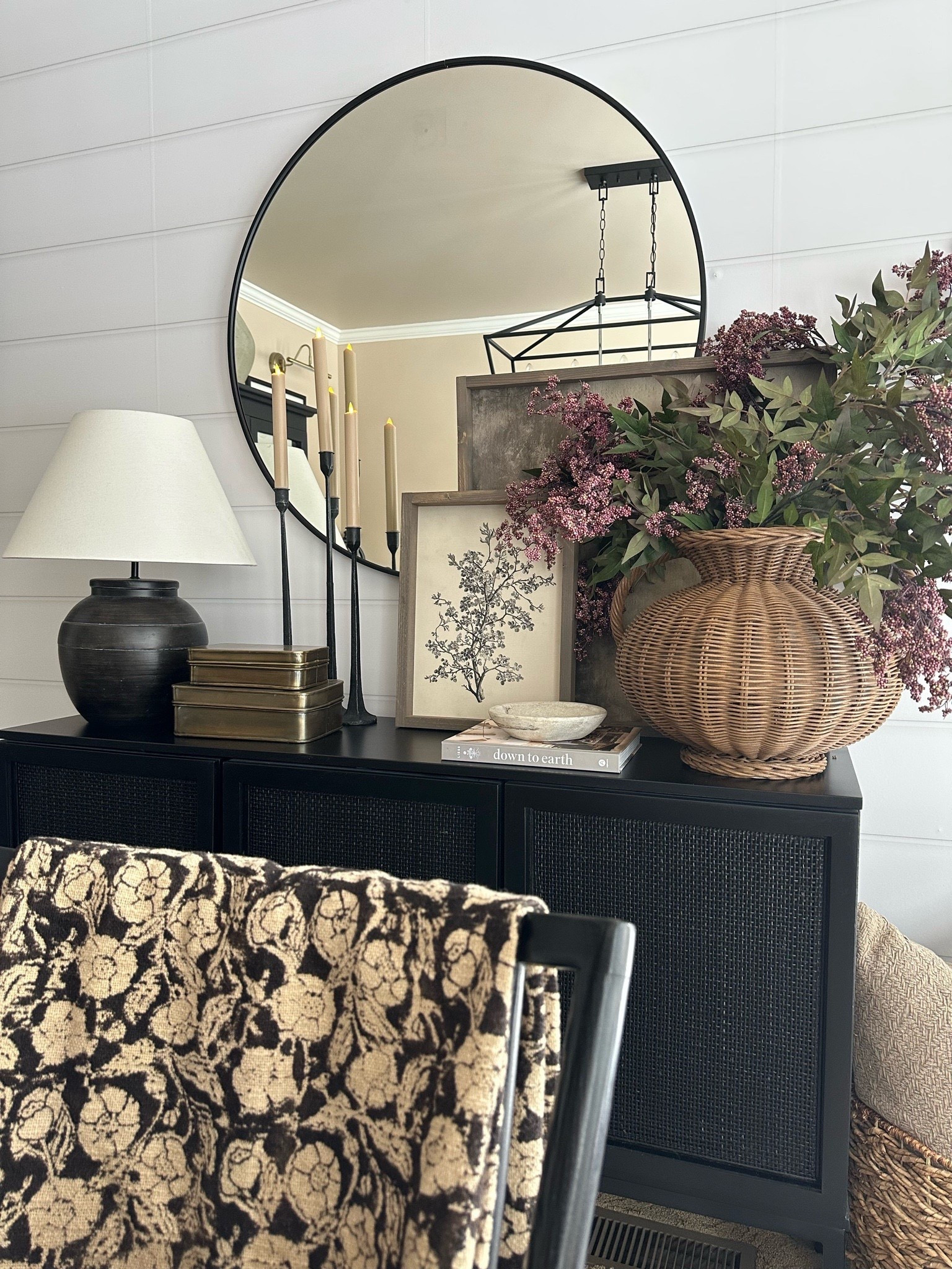 Modern Organic Sideboard Decor with Round Black Mirror

Follow @farmtotablecreations on Instagram for more cozy home inspiration.

This sideboard vignette brings together warm neutrals, layered textures, and timeless accents for a clean modern organic look. The round black mirror adds depth and contrast, while stacked art, soft candlelight, and a woven wicker vase filled with faux berry stems keep the styling grounded and inviting. It’s a simple way to create a statement moment without overwhelming the space—perfect for a dining room, entryway, or living area.

The build-a-sign frame feature is 15% off with my code FARMTOTABLE.
For reference:
Botanical Print 12x16
Abstract Art 24x24
Both in Briarsmoke stain

#sideboarddecor #roundmirror #consoledecor #modernorganic #neutraldecor #homedecor #interiorstyling #wovenaccent #candlesticks #wallart

#LTKSaleAlert #LTKFindsUnder50 #LTKHome