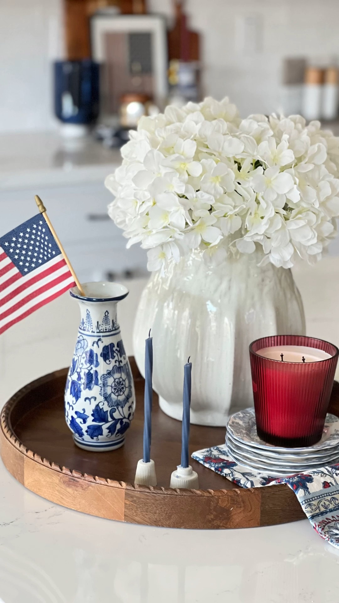 Patriotic hostess decor, blue and white chinoiserie vase, patriotic kitchen island styling, Americana decor, red white and blue decor, summer hostess decor, Memorial Day decor, Fourth of July decor, dessert plates, blue toile dessert plates, layered tray styling, wooden tray decor, kitchen island centerpiece, hostess aesthetic, collected home decor, classic Americana style, Ralph Lauren inspired decor, blue and white home decor, candle styling, entertaining essentials, kitchen counter styling, elegant patriotic decor, neutral kitchen decor, modern traditional decor, hosting pieces, decorative trays for kitchen island, hydrangea arrangement, everyday hostess styling

#LTKHome #LTKSeasonal