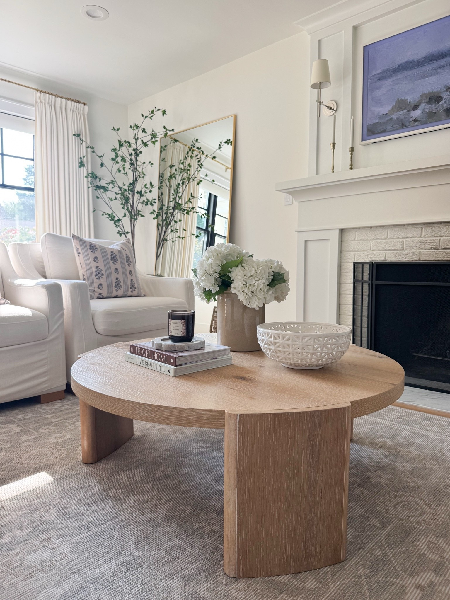 If you're creating a layered neutral living room, these are the pieces I reach for again and again. This round white oak coffee table has been my top seller—and for good reason. The size and scale are perfect for everyday living, and after almost two years with our family of five, it still looks as beautiful as the day it arrived.

I'm also linking my durable neutral patterned rug, ceramic lattice bowl, and favorite beige crock with faux hydrangeas—simple, timeless pieces that add warmth, texture, and make a space feel effortlessly collected.
