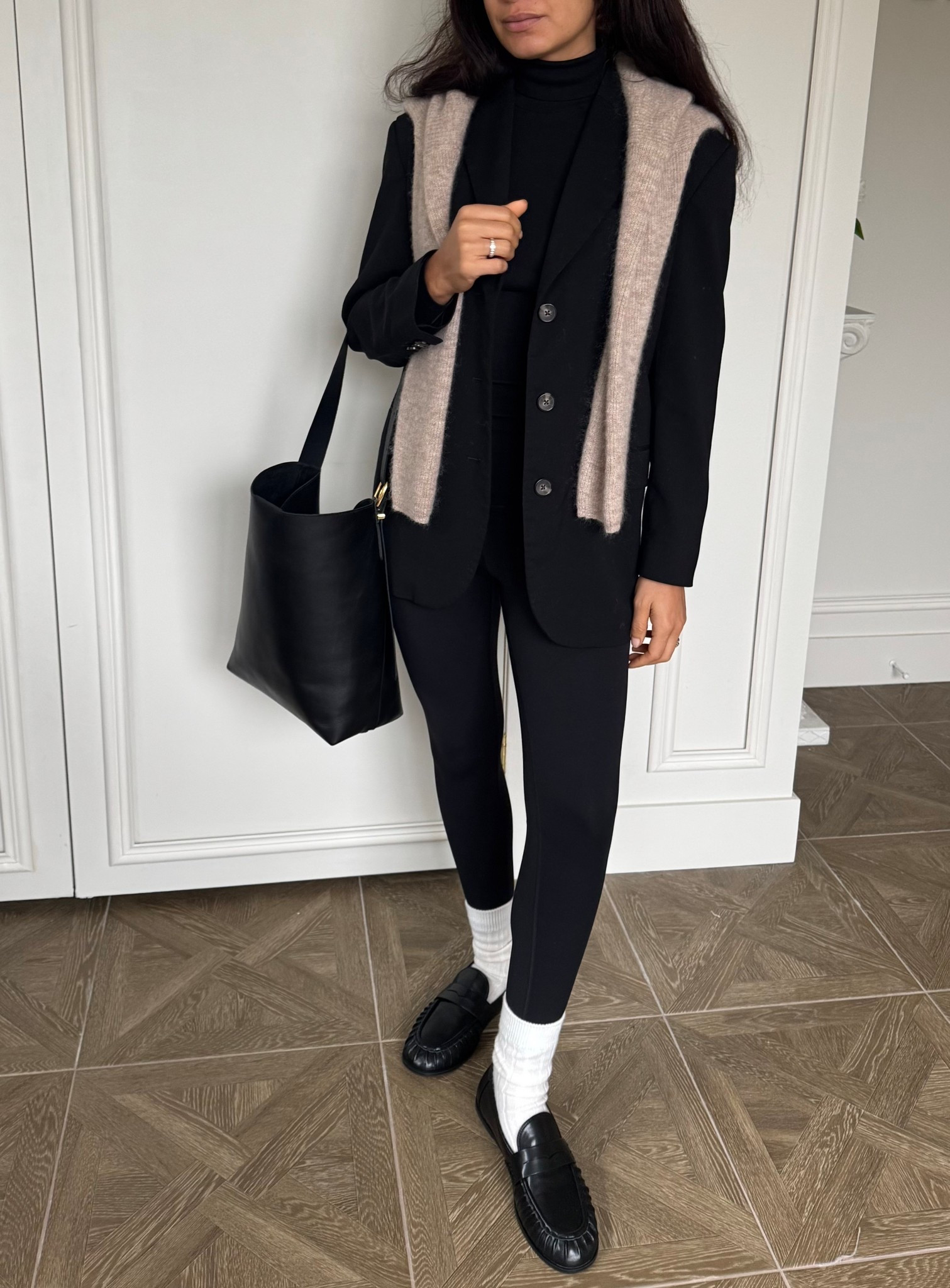 Elevated casual leggings outfit: leggings, cashmere socks, penny loafers, turtleneck, oversized blazer, bucket tote bag, oval sunglasses, and a draped sweater 

#LTKootd