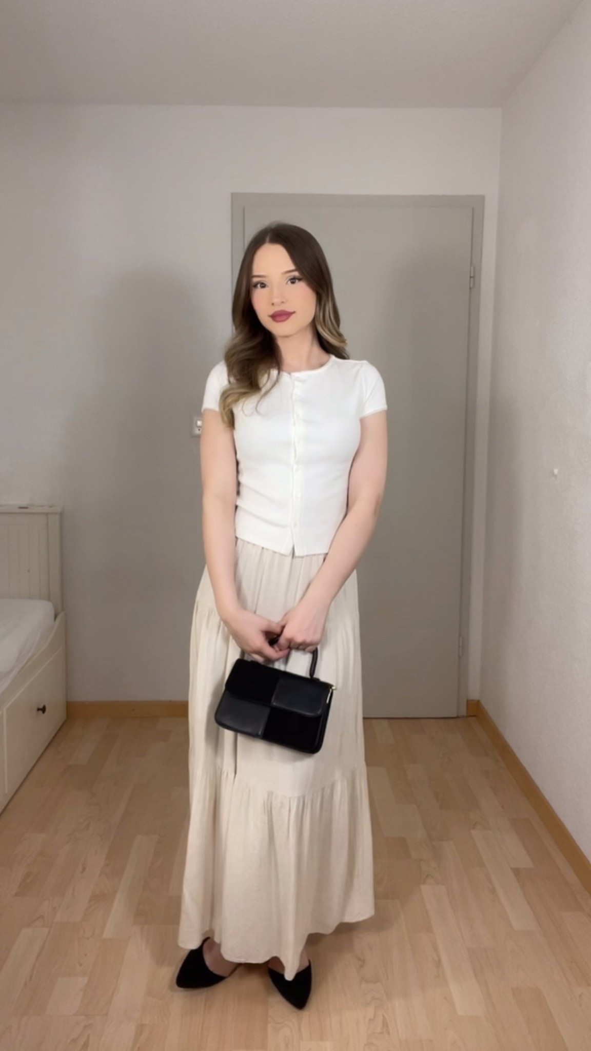Neutrals will always be in style. This elegant minimalist outfit is a go-to for everyday chic! I paired a fitted white buttoned top with a soft beige maxi skirt, and styled it with classic black pointed flats and a sleek black mini handbag for a balanced, effortless look. Perfect for a coffee date, city stroll, or a casual office day. Neutral tones, timeless cuts, and feminine touches—this is quiet luxury on a budget!

#LTKstyle #neutraloutfit #quietluxury #minimalstyle #elegantlook #frenchgirlstyle #classicfashion #springoutfitideas #neutraltones #femininefashion #chicandclassic #budgetfashion #LTKunder100 #softaesthetic #dailyoutfitinspo #capsulewardrobe #styleedit #timelessstyle #blackandwhiteaesthetic #easyelegance #outfitdetails
