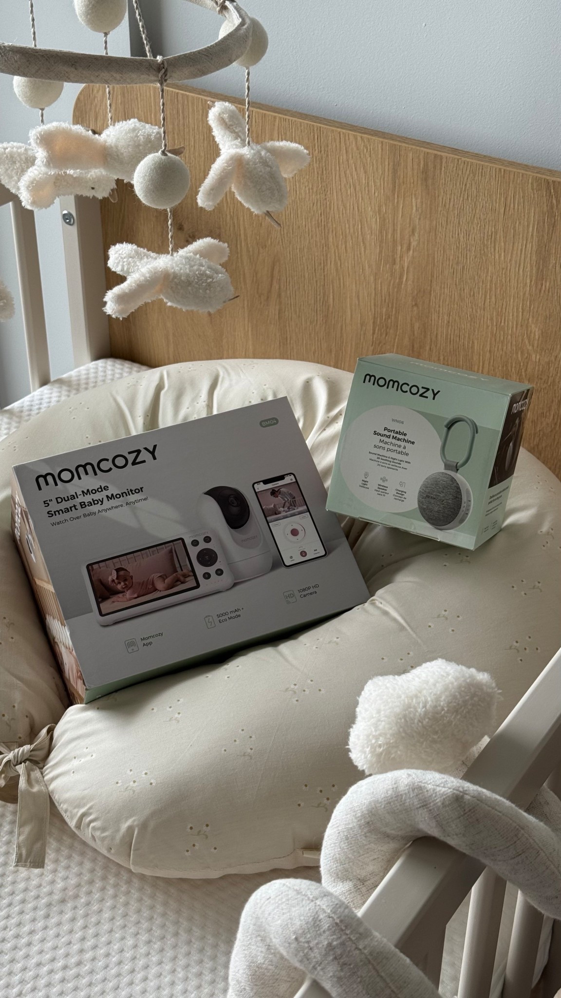 Newborn essentials, crib, sound machine, baby monitor, momcozy 