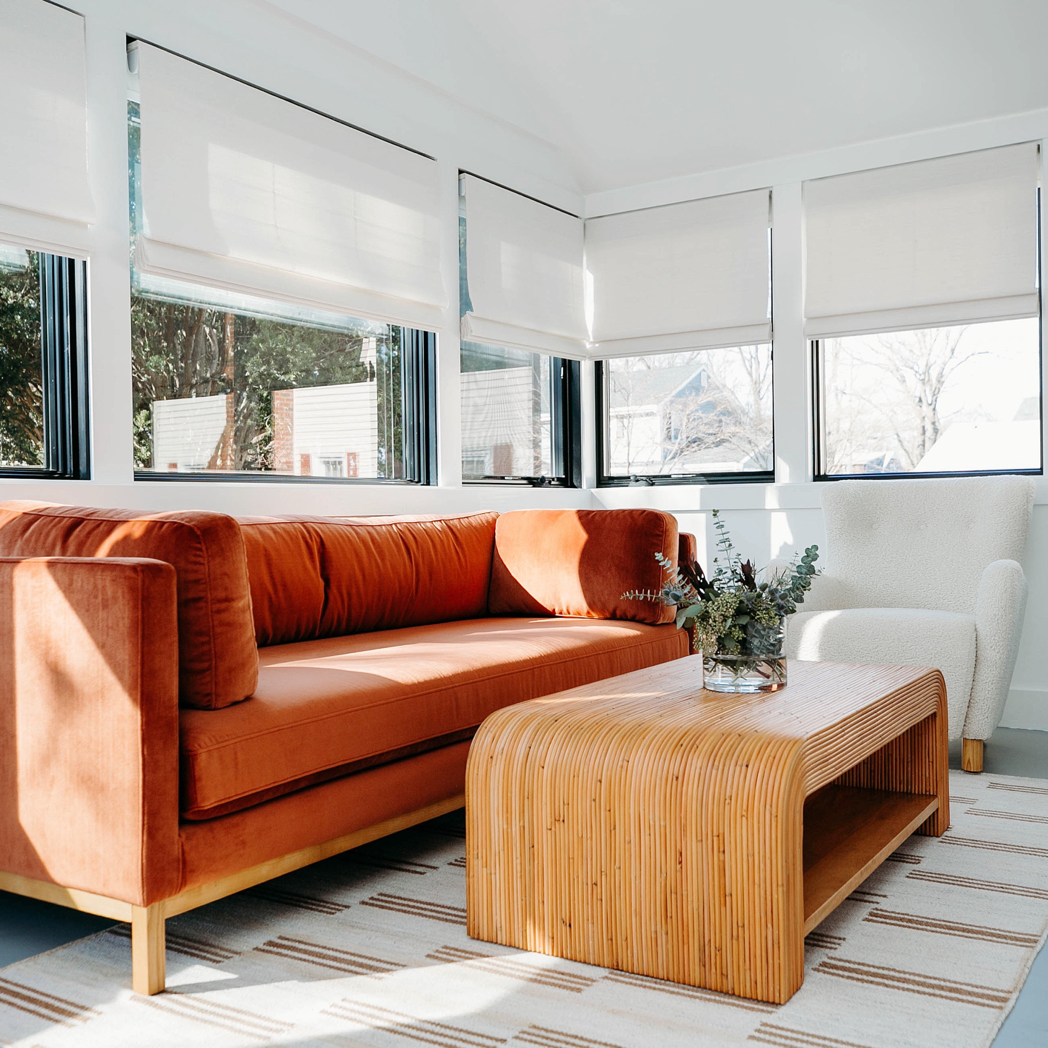 talk about a glow up! this light-filled sunroom was formerly an overlooked three-season porch that transformed into one of the best spots in the house. #dwelloctoberstudios vaulted the ceiling and painted the room white to create an open, airy feel. new windows allow the natural light to stream in, while a rattan coffee table, velvet couch, and bouclé chair add layers of texture but still keep the space comfortable and inviting. #dwelloctoberrealesate #dwelloctober

#LTKHome