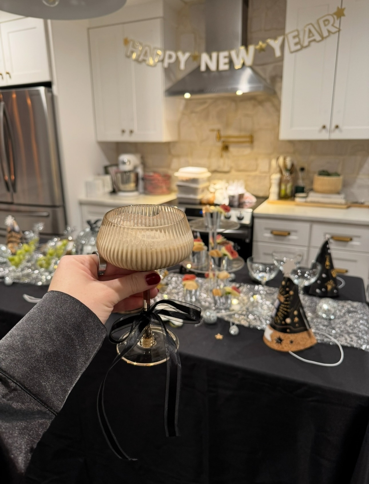 NYE hosting inspo 🥂🪩✨

It’s all in the details + adding high impact items to bring your NYE setup to life 

Comment 2026 for the links!

DISCO BALLS:  add the perfect sparkle and time square touch to any tablescape or mantle 

CHAMPAGNE TOWER: add bows or tinsel sticks to your glassware for a festive new years toast

APPS: I usually go for lighter snacks like champagne sugar grapes or mini charcuterie cups in addition to a heavier entree (usually Chinese takeout 🥡)

COCKTAILS: the bartesian is the perfect touch to allow guests to chose their own cocktail or mocktail without being tied to the bar all night 

DESSERT: add in festive “clocks” with black icing and Oreos on a pre made cake or a chocolate fountain for unlimited dipping fun 

DECOR: black, gold, silver, tinsel, glitter, party hats, and oversized foil numbered balloons all add to the chic theme

#tablescape #tablescapestyling #newyears #newyearseve