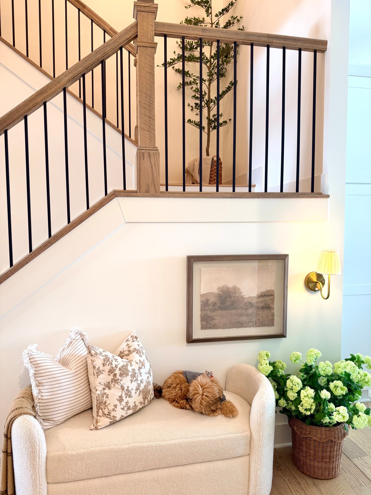 Cozy corners are my favorite 🤍

This little stair nook is officially complete and might be the sweetest spot in the house. The soft boucle bench, layered neutral pillows, warm brass sconce, and that beautiful wood railing all come together to create the most inviting moment. And of course… Teddy approved 🐾✨

Sharing all the details linked here from the bench to the pillows and wall sconce. It’s proof that even the smallest spaces can feel intentional and cozy.

#LTKOver40 #LTKSpringSale #LTKHome