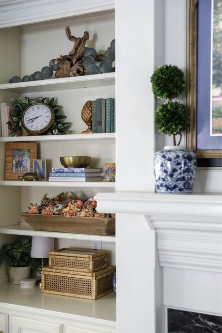 Do you need ideas for your bookcase decor? Mine has a grapewood branch, sea glass beads, a clock, books, a dough bowl, picture frames, boxes, faux plants, candles and a small lamp.

#LTKhome