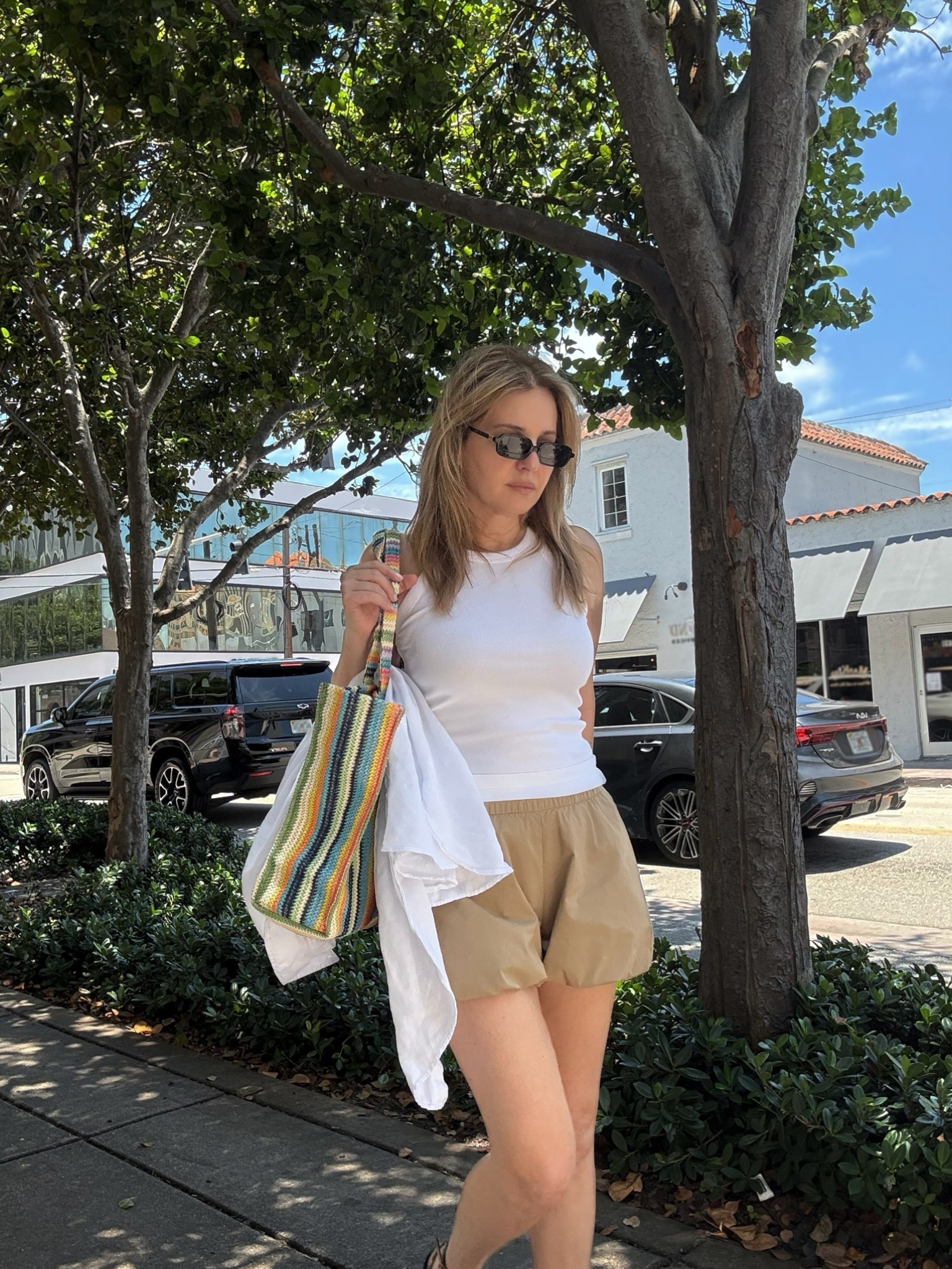 Summer outfit wearing a white ribbed tank w khaki bubble shorts, my multi-colored raffia tote bag and sunnies ☀️

#LTKSeasonal #LTKootd #LTKSaleAlert