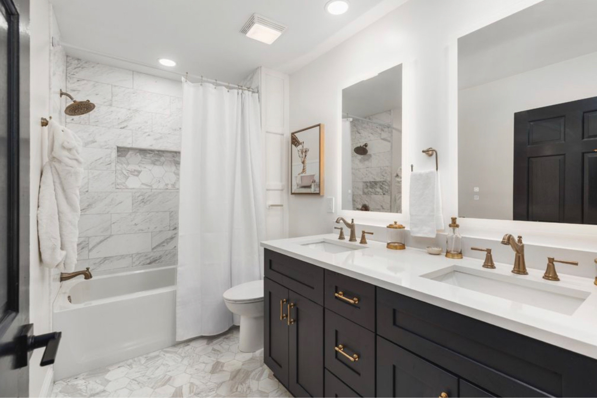 This is the perfect guest bathroom or kids bathroom! The light mirrors make for the perfect place to get ready! We did this bathroom in Volakas Marble from the Tile Shop, the vanity is a custom depth and made vanity, however I linked similar ones. This is such a great shower curtain! The delta fixtures are beautiful and work like a dream! 

#LTKBaby #LTKHome #LTKStyleTip