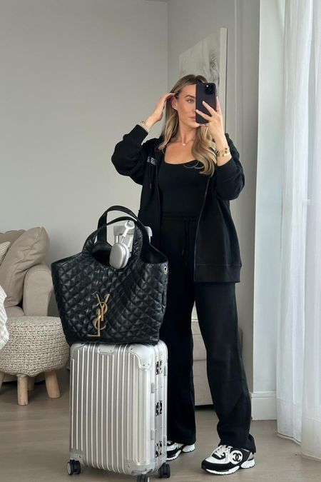 A chic + comfortable look perfect for travelling + keeping warm when I arrive in the alps. I’m wearing a new-in black tracksuit from ganni, layered with a black skims vest top + chanel trainers. The look is finished off with my apple airpods max, new ysl tote bag + rimowa carry on case.

#LTKeurope #LTKtravel #LTKstyletip