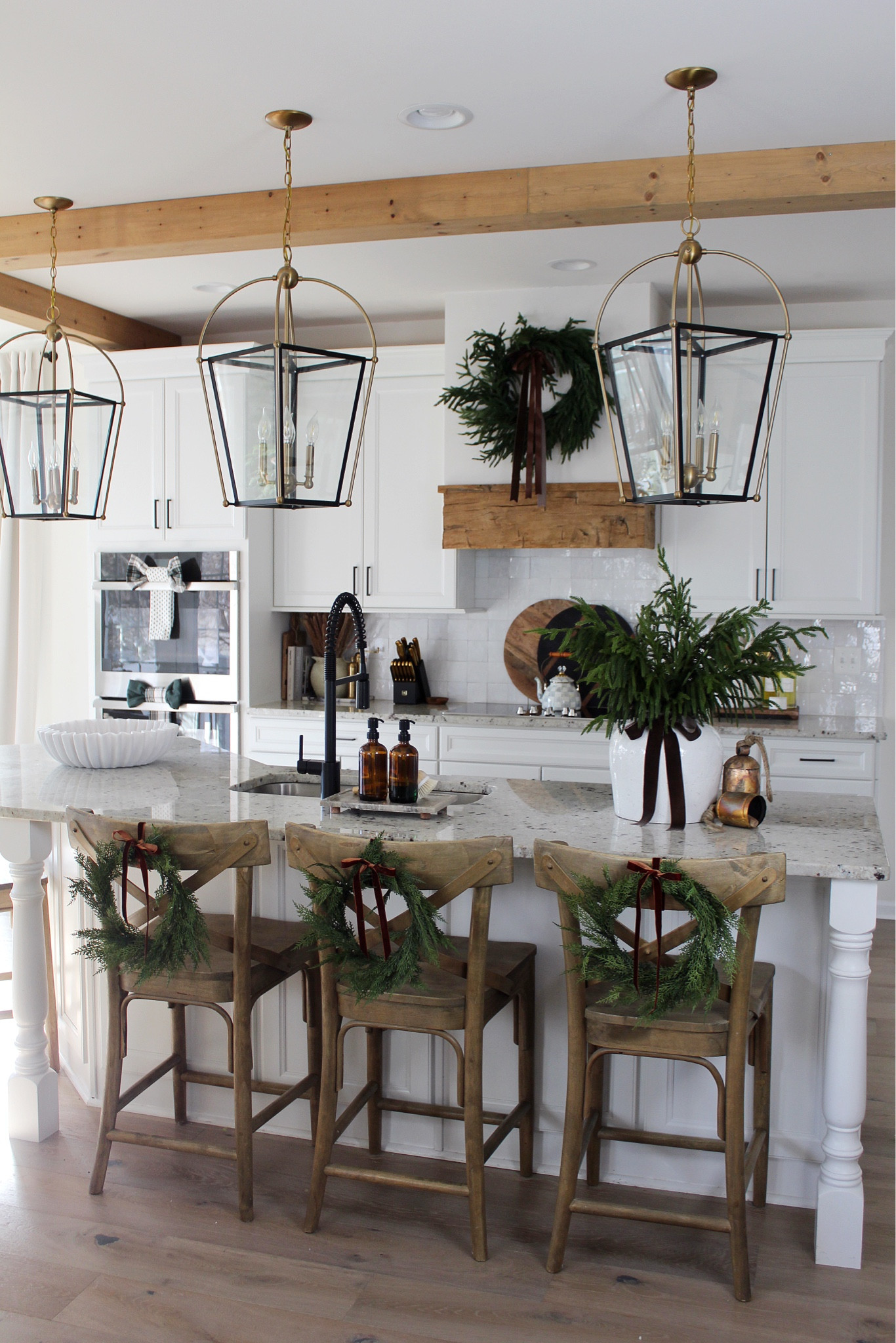 Holiday kitchen decor: kitchen counter stools, vase, wreath, Norfolk stems, bells, rug, 

#LTKHoliday #LTKCyberWeek #LTKHome