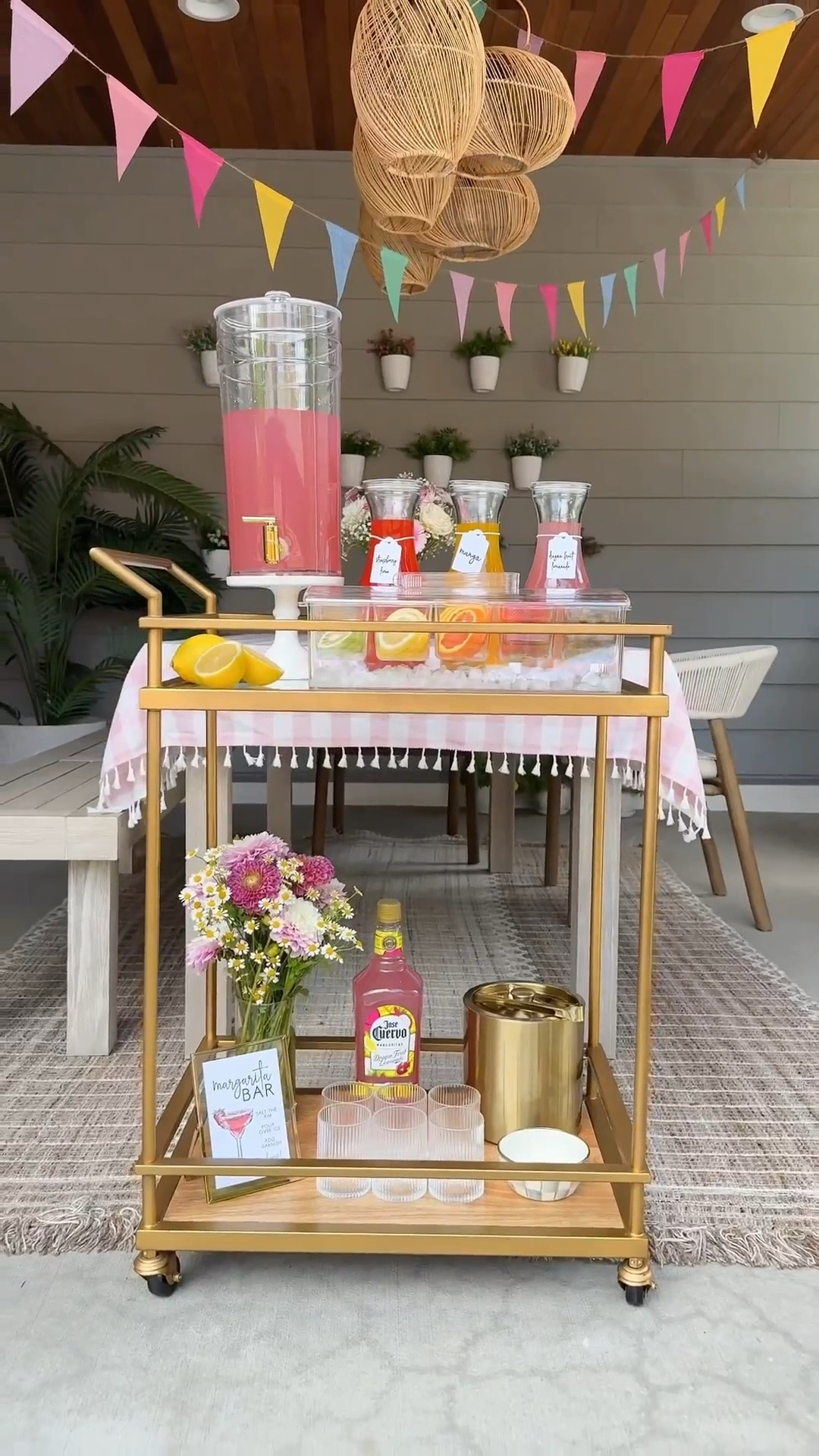 MARGARITA BAR CART! 🌸🍹🍓🍋✨ I love setting up  a self-serve drink bar so guests can make their drink however they’d like. This one was a hit! #magaritas #drinkstation #barcart

Bar cart, glassware, bowl, metal ice bucket, server caddy, glass carafe, pink checkered tablecloth, outdoor furniture, table, chairs, rug, planter, patio furniture, rainbow flag banner 

#LTKParties

#LTKsummer #LTKhome