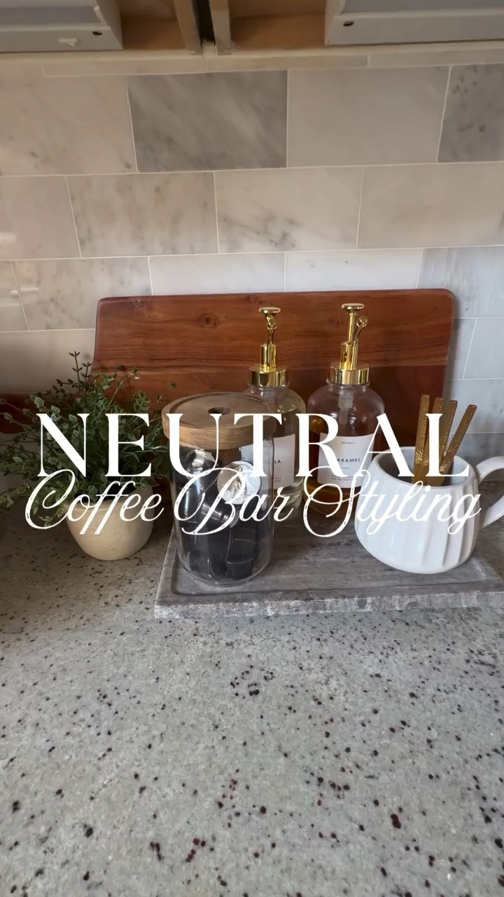 Neutral coffee bar styling 🫶There’s just something about a cozy, neutral coffee bar that makes home feel extra inviting 🤍☕️

I love styling this little corner with simple pieces that feel elevated but still functional… from the warm acacia wood cutting board and marble riser to my favorite glass syrup dispensers and gold details ✨

The little touches make all the difference — and honestly this setup makes my morning coffee feel a little more special every single day.

If you love cozy neutral home styling, affordable decor finds, and simple ways to make your home feel designer-inspired… follow along because there’s so much more to come 🫶🏻

#coffeebarstyling #neutralhome #homeinspo #coffeestation #cozyhome

#LTKHome