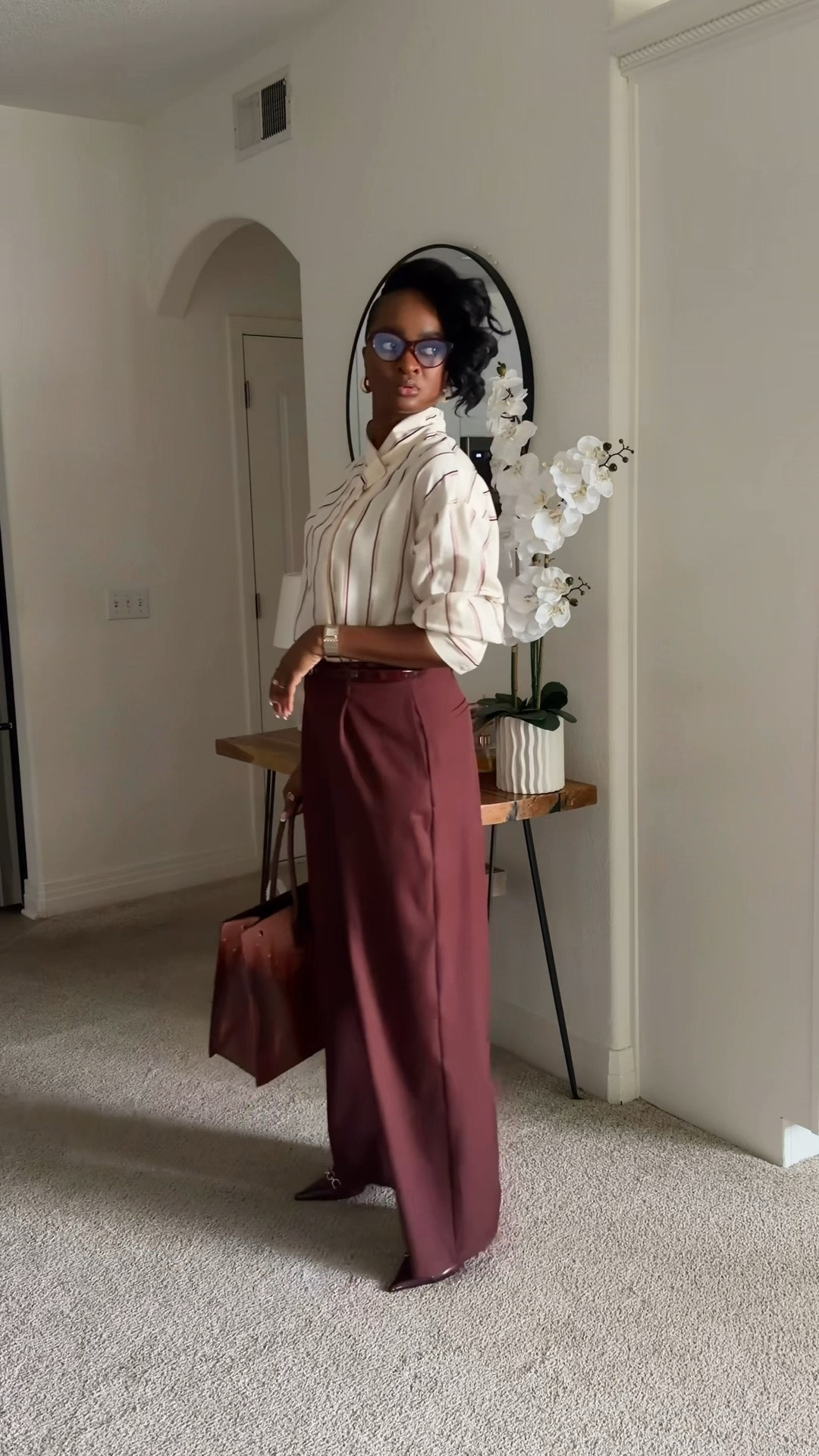 Back to the grind after a great weekend at NYFW. Transitioning my workwear into Fall looks.

For Part III of the Corporate Chic edit, we’re talking Off-White & Wine, a cool color palette for the seasonal shift. 

Pairing a crisp cream striped blouse with deep burgundy wide-leg trousers creates that effortless balance of light and rich tones. It feels sophisticated, modern, and instantly elevated for the office.

How are you styling deep wine tones this season?

Blouse @primark 
Pants @fashionnova 
Shoes @justfabonline 
Purse @ilomanyy

#LTKWorkwear #LTKTall #LTKootd