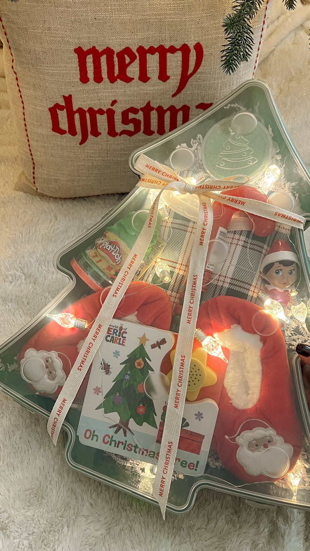 Festive December idea for kids 🎄 I turned this plastic Christmas tree box into a fun little gift filled with toddler PJs, slippers, a book, treats, Play-Doh, and lights. Such an easy, affordable way to surprise your toddler or child and start the month with some holiday magic. These gift boxes are great for kids, friends, neighbors, and co-workers — and they come in other super cute shapes!

toddler Christmas gift ideas • December box ideas for kids • holiday toddler ideas • Christmas traditions for toddlers • festive December ideas • kids Christmas gift ideas • Christmas tree gift box • easy holiday gift ideas • affordable kids gift ideas • toddler Christmas activities • December 1st box ideas • kids holiday surprise ideas • Christmas ideas for moms • toddler stocking stuffers • creative Christmas gift ideas • holiday ideas for busy moms • Christmas ideas for toddlers and kids • festive gift box ideas • holiday gifts for neighbors and friends 

#LTKGiftGuide #LTKmomlife #LTKHoliday