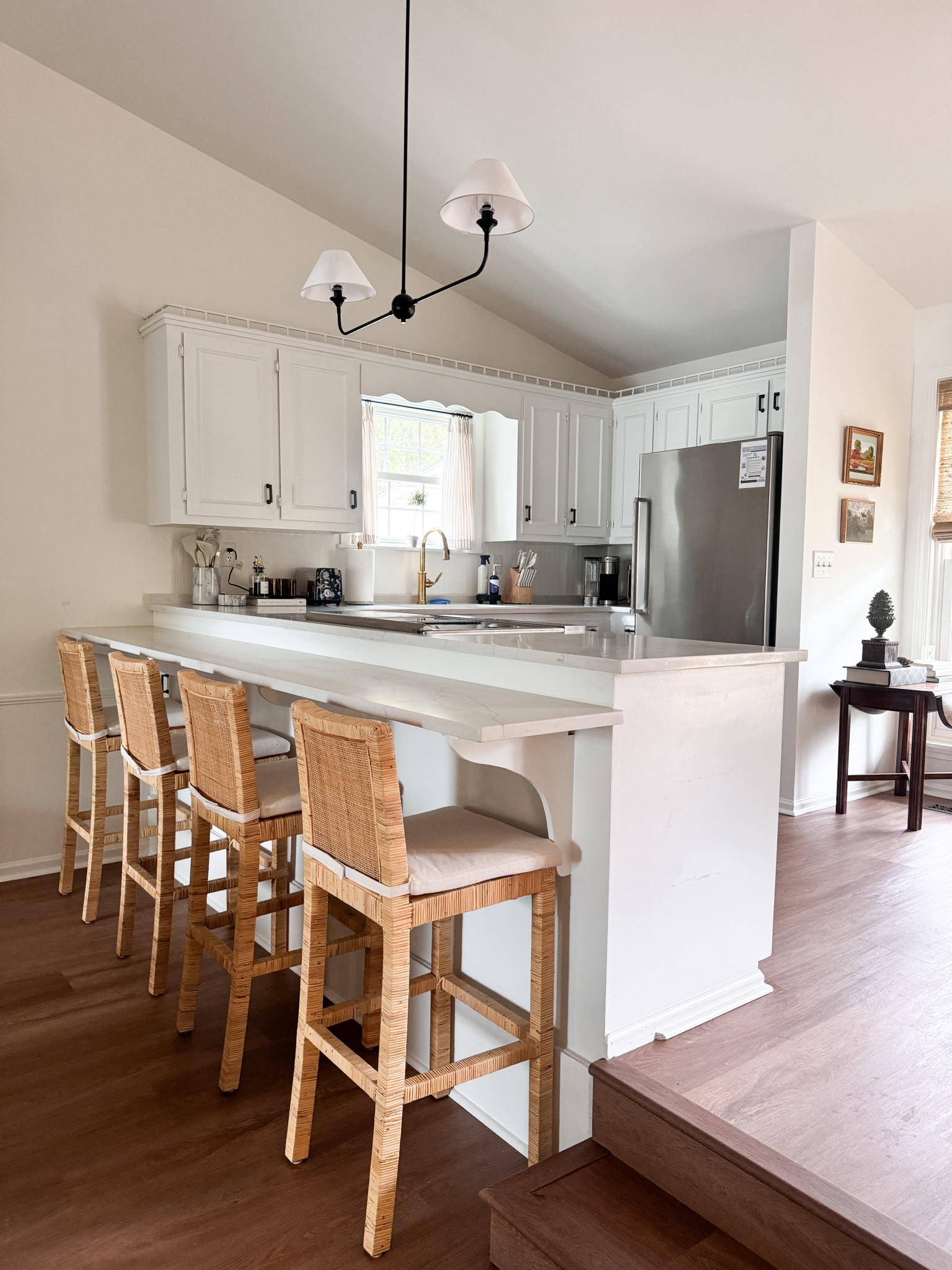 Cane weave kitchen counter stools that come with cushions! West elm look-for-less linear chandelier from Amazon! Unpolished brass faucet fixture from Wayfair 

#LTKSaleAlert #LTKHome #LTKStyleTip