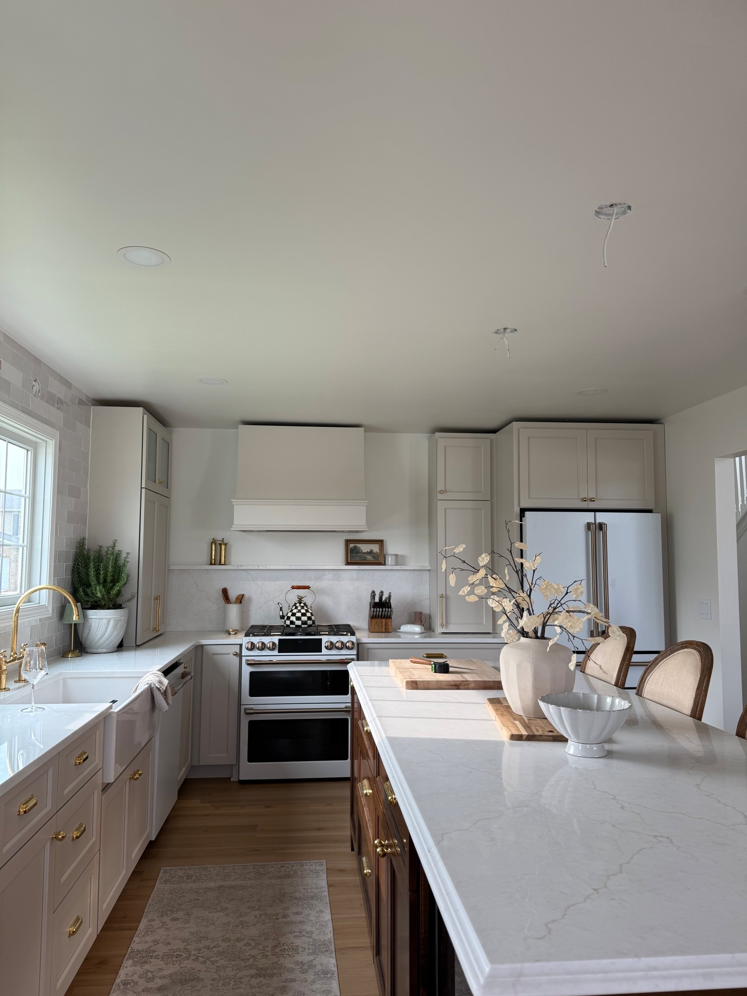 Our dream kitchen is almost complete—and it’s a blend of traditional charm and modern elegance, just like Shea McGee herself stopped by to help! ✨ We chose Accessible Beige by Sherwin Williams for the cabinets and Greek Villa on the walls to keep things light, airy, and timeless. The unlacquered brass hardware adds that perfect hint of patina, and I couldn’t resist finishing it off with a classic MacKenzie-Childs Courtly Check tea kettle for a pop of personality.

We’re loving our Café Appliances in Matte White with brushed brass hardware—they elevate the whole space with a custom, high-end feel. The mix of warm neutrals, traditional lines, and modern touches makes this kitchen feel inviting and elevated all at once.

✨ Tap to shop our exact appliances, paint colors, hardware, and curated kitchen decor.

#LTKHome