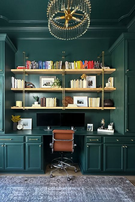 An office makeover in the most gorgeous green: #Behr Marquee Black Evergreen. There’s shelves + storage from stock cabinets turned built ins. 🤩 Trim + a gorgeous light to top it off. Do we love it??? #diy #office #books #homereno #loweshomeimprovement #pepeandcarols (hardware) #lovelauradavidson (chair) 

#LTKhome #LTKFind #LTKstyletip
