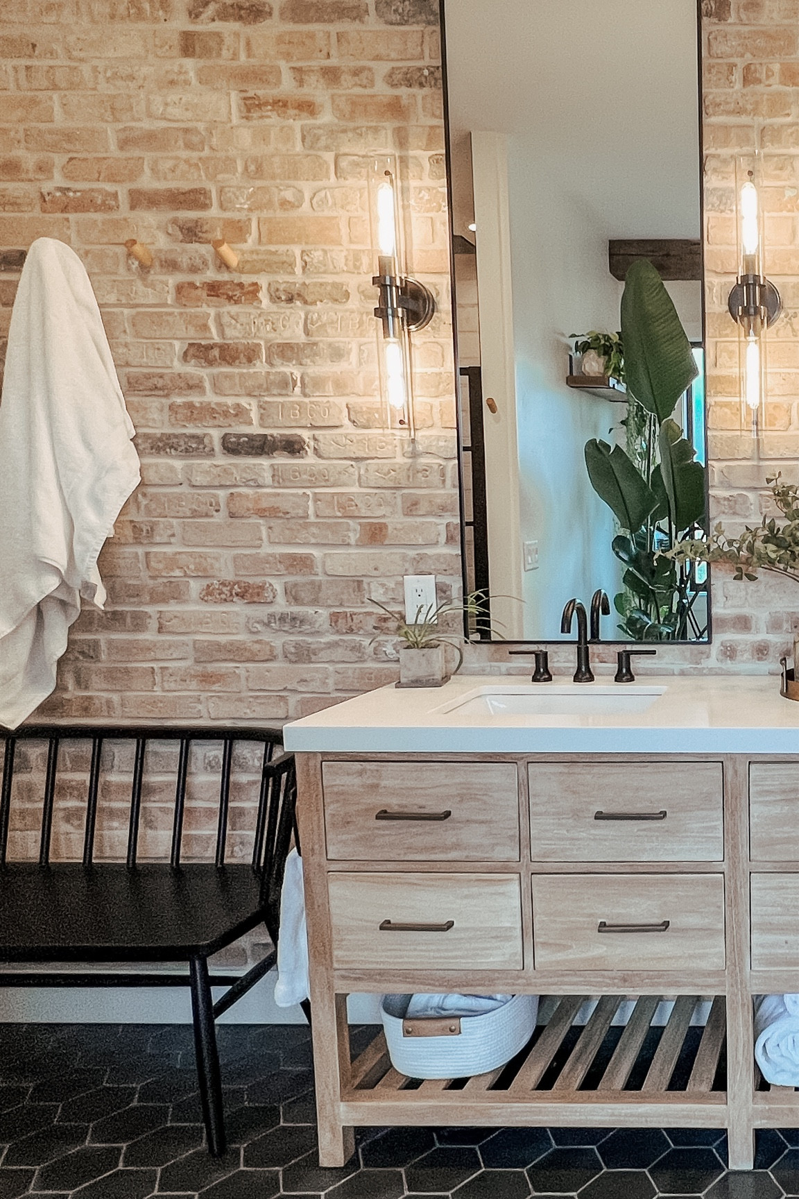 A picturesque  corner of our master bathroom. 

Master bathroom, vanity, Restoration Hardware dupe mirrors, XL vanity, open wood vanity, bathroom bench, shaker seating, towel hooks, modern faucet, bathroom sconces, vintage brick wall

#LTKHome
