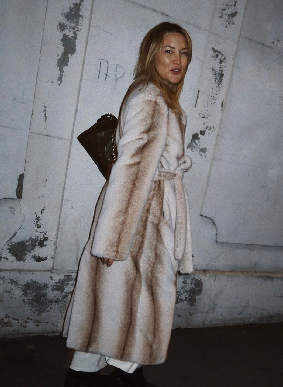 Kate Hudson's so fur coat,  Elegant minimal design makes this long line faux fur coat an ultimate wardrobe piece for winter season. Collarless silhouette is a classic chic look for every occasion.

