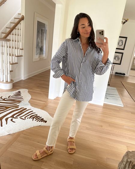 Kat Jamieson wears a blue and white stripe button down shirt and bone colored denim jeans from @saks with raffia sandals. Spring sandal, spring outfit, classic style. #saks #sakspartner

#LTKSeasonal #LTKworkwear #LTKshoecrush