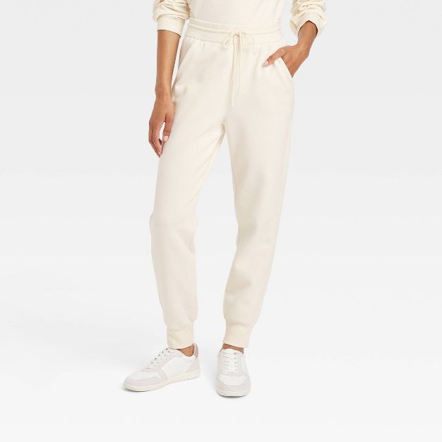 Women&#39;s High-Rise Fleece Jogger Pants - Universal Thread&#8482; Cream XS | Target