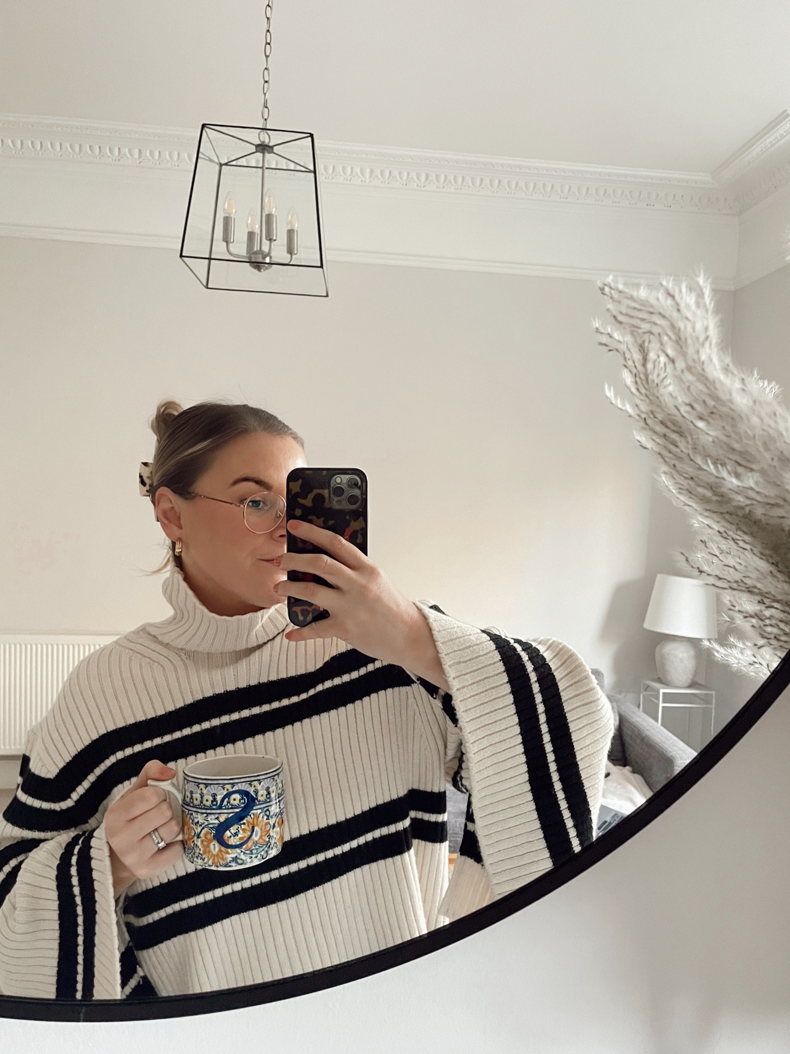 Parisian chic knitwear H&M oversized striped turtleneck knit. Hair in a claw clip and anthropology mug. Simple minimal style 

#LTKunder50 #LTKSeasonal #LTKeurope