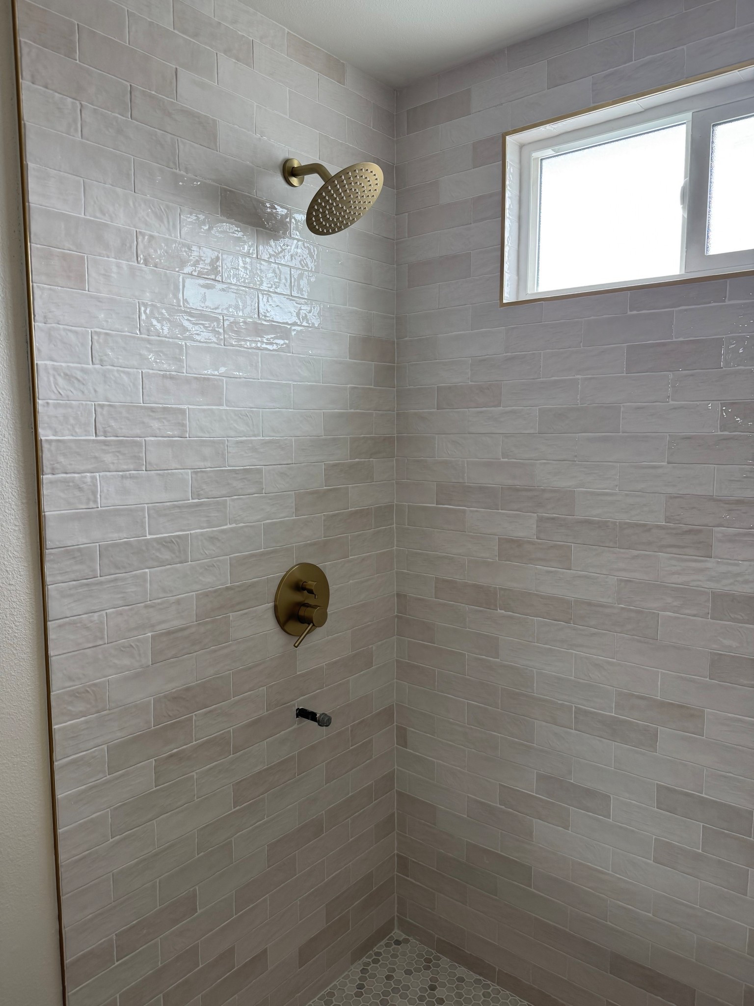 Close up of the tile! It can look pink or crème in certain lighting, but this color is the Ivy Hill Tile Kingston White. Size 3x8 in.! The faucet wasn’t finished but that’s linked too. 

#LTKHome