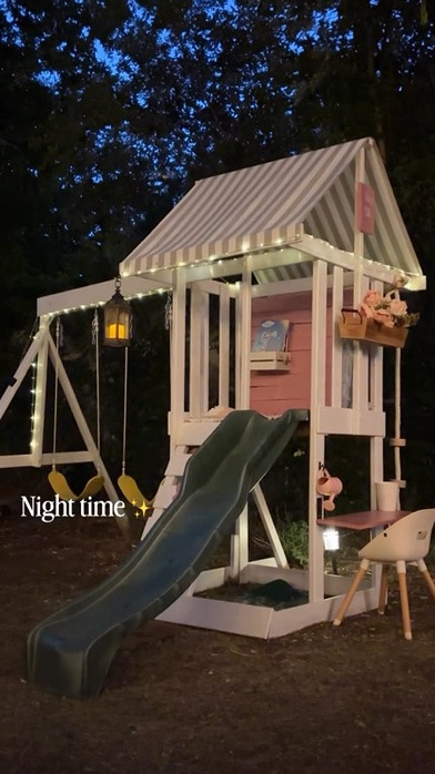 From sunny morning adventures to twinkle-light evenings… ✨🤍

Watching this little corner of our backyard come to life has been one of my favorite DIY projects. During the day it’s filled with muddy boots, giggles, and endless imagination. At night, the soft lights make it feel like a tiny storybook cottage tucked away just for two little girls.

It’s amazing how a little paint, a few thoughtful details, and some warm lights can completely change the feeling of a space. This isn’t just a swingset anymore—it’s where childhood memories are being made from sunrise to bedtime.

Which version would you choose… ☀️ Day or ✨ Night?