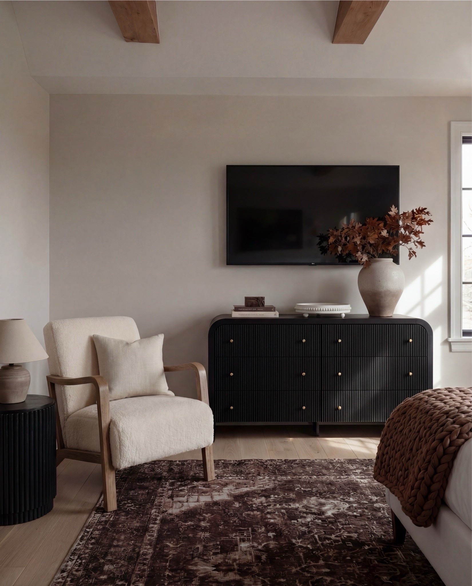 Shop the Look:
• White upholstered wingback bed frame
• White cotton duvet cover + pillow shams
• Textured throw pillows (rust + black patterned)
• Chunky knit throw blanket (warm brown)
• Vintage-style brown area rug
• Dark wood nightstands with brass knobs
• Ceramic table lamp (neutral glaze)
• Brass globe wall sconces
• Framed floral artwork (muted tones)
• Arched brass wall mirrors
• Upholstered bench at foot of bed (camel brown)
• Cream accent chair with wood arms
• Black fluted dresser with brass pulls
•Ceramic beige decor bowl
•Decor wood beads 
•Decor book
• Large ceramic floor table vase (earthy clay tone)
• Decorative wood bead garland
• Sheer white curtain panels
•Decor tray
•Hurricane candle holder
Wood Jewelery box 

#LTKSaleAlert #LTKHome