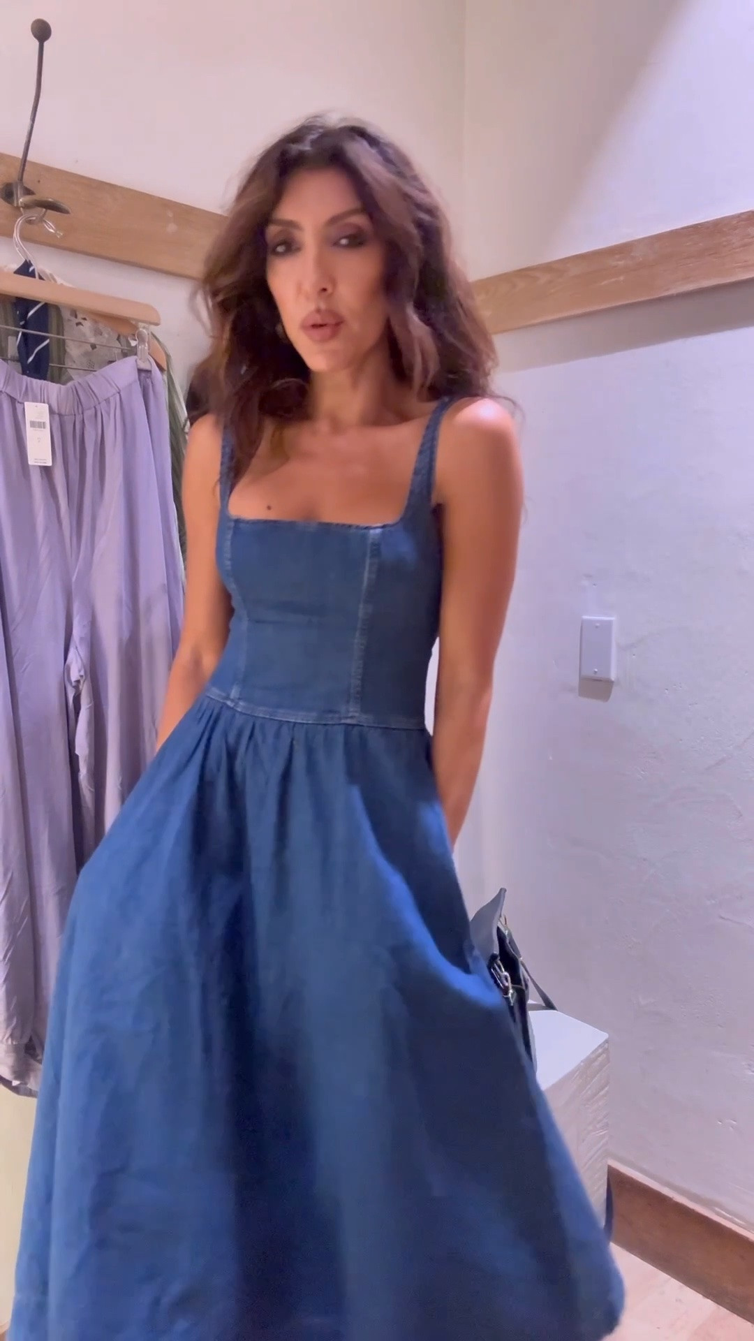 A timeless denim-blue midi dress with a flattering square neckline, wide straps, a fitted structured bodice, and a softly gathered A-line skirt. It’s feminine, effortless, and comfortable, with pockets that make it an everyday essential you’ll reach for again and again.
Ways to style it
•	Keep it casual with white sneakers, a tote bag, and delicate gold jewelry
•	Add flat sandals and a straw bag for an easy summer or vacation look
•	Dress it up with heeled mules, statement earrings, and a sleek shoulder bag
•	Layer a crisp white button-down or lightweight cardigan over it for cooler evenings
•	Wear a fitted tee or blouse underneath for a fresh layered look
•	Add a blazer and loafers for a polished daytime outfit
•	Pair it with boots and a leather jacket when the weather cools down
•	Define the waist with a belt and switch up the mood with bold accessories
It’s one of those versatile, must-have basics you can style differently every time. Easy enough for errands, yet elevated enough for brunch, dinner, travel, and everything in between.

#LTKOver40 #LTKWorkwear #LTKmomlife