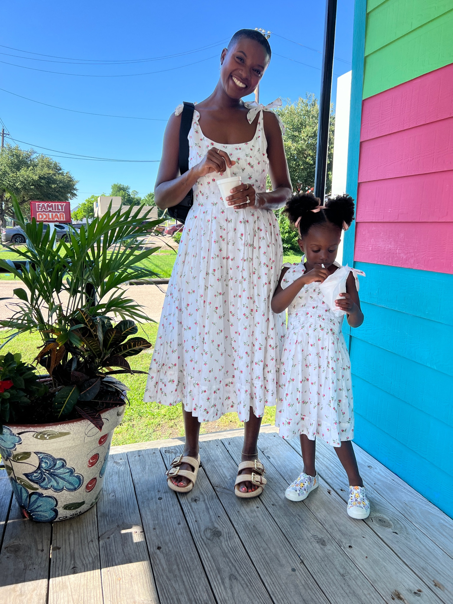 Mommy and me dresses! White dress with pink florals and shoulder tie straps. I’m wearing tan canvas double buckle  slide sandals and my toddler is wearing floral shoes  

#LTKFamily #LTKKids #LTKFindsUnder100